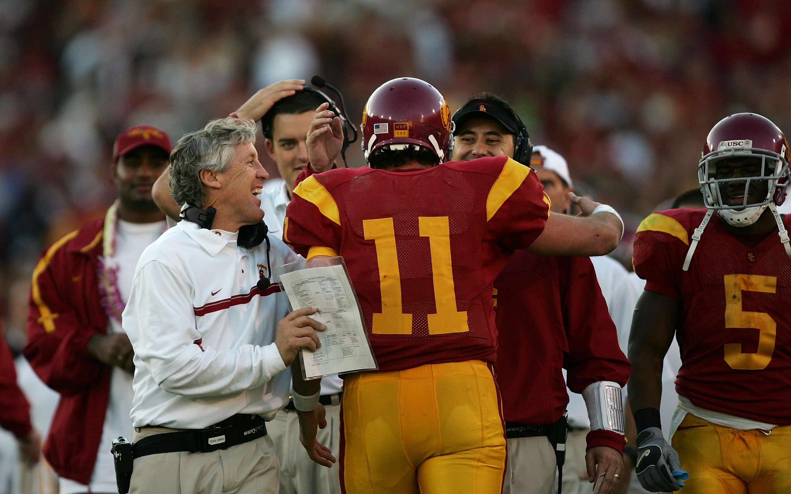 LOS ANGELES, CA - DECEMBER 03:  Matt Leinart #11 of the USC Trojans celebrates with USC head coach Pete Carroll and other assistant coaches after USC scored a touchdown to take a 52-6 lead in the third quarter against the UCLA Bruins December 3, 2005 at t