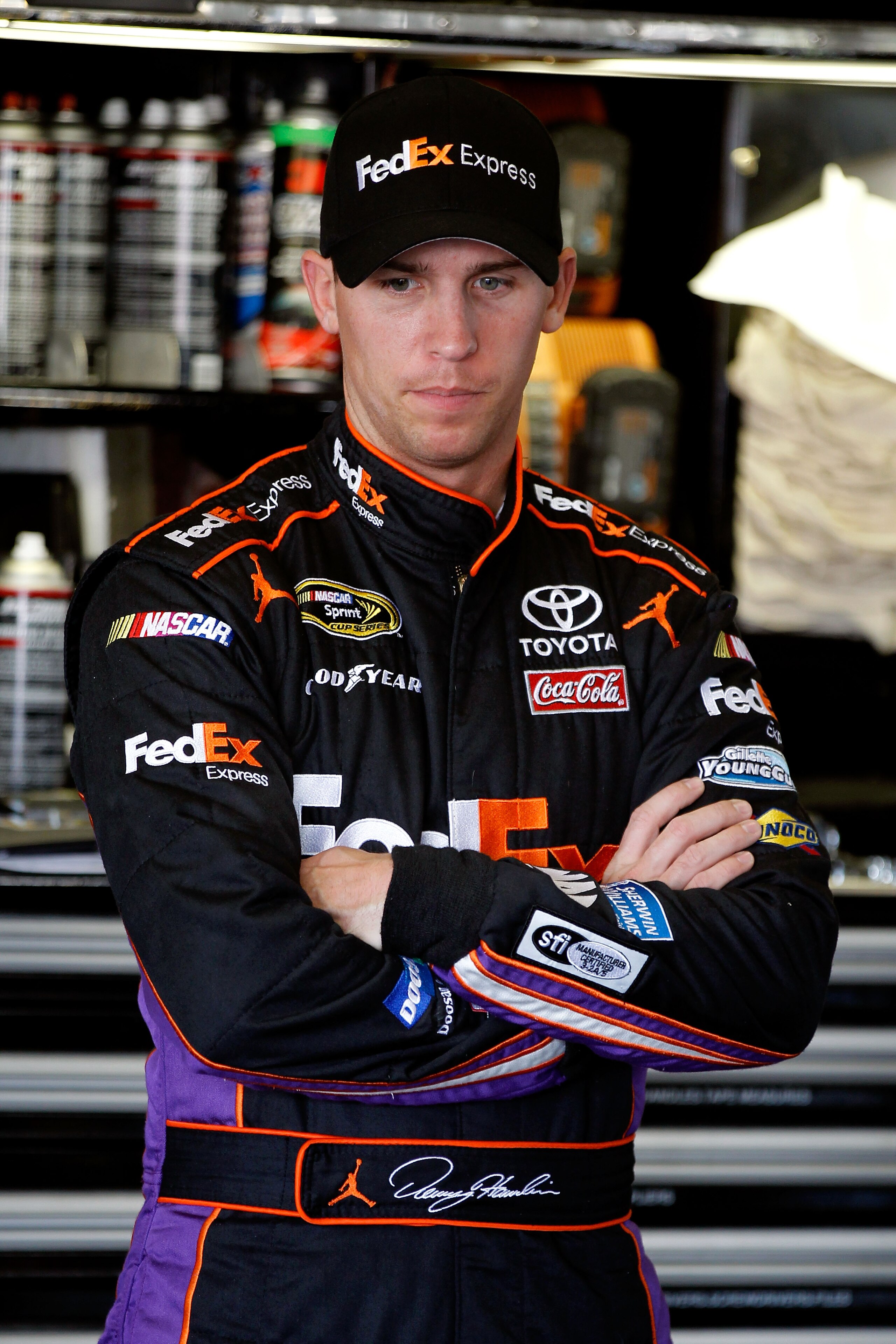 DAYTONA BEACH, FL - FEBRUARY 19:  Denny Hamlin, driver of the #11 FedEx Toyota, looks on in the garage area during practice for the NASCAR Sprint Cup Series Daytona 500 at Daytona International Speedway on February 19, 2011 in Daytona Beach, Florida.  (Ph