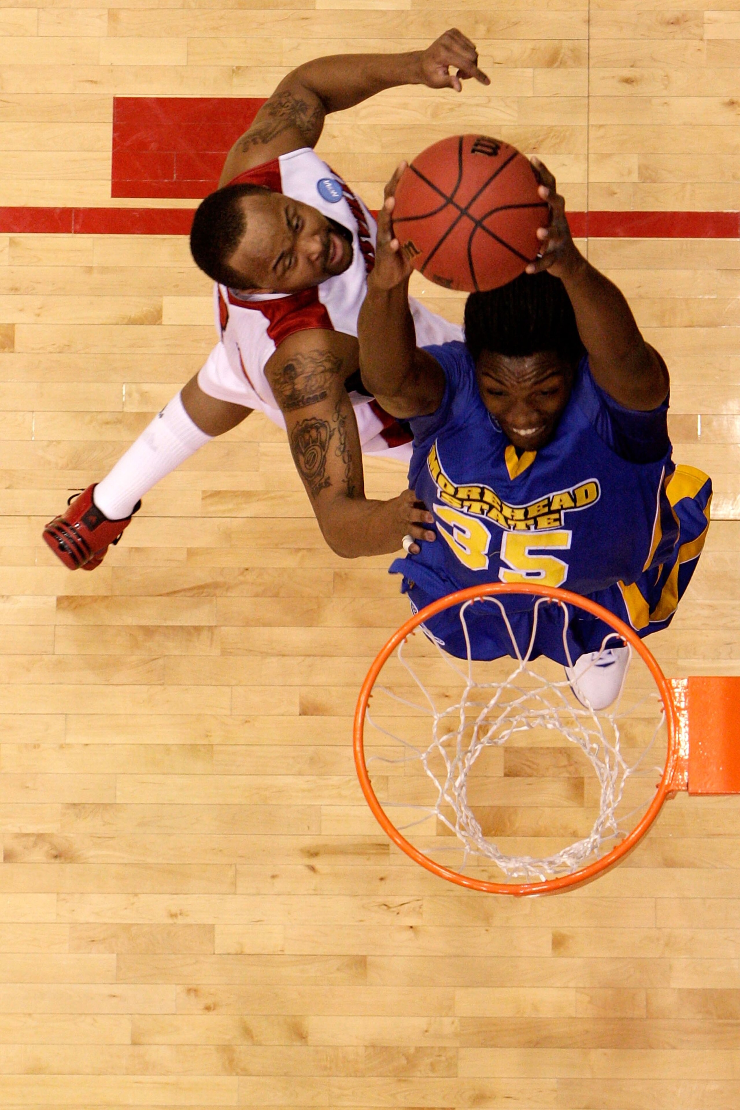 DAYTON, OH - MARCH 20: Kenneth Faried #35 of the Morehead State Eagles drives to the hoop against Jerry Smith #34 of the Louisville Cardinals during the first round of the NCAA Division I Men's Basketball Tournament at the University of Dayton Arena on Ma DAYTON, OH - MARCH 20: Kenneth Faried #35 of the Morehead State Eagles drives to the hoop against Jerry Smith #34 of the Louisville Cardinals during the first round of the NCAA Division I Men's Basketball Tournament at the University of Dayton Arena on Ma