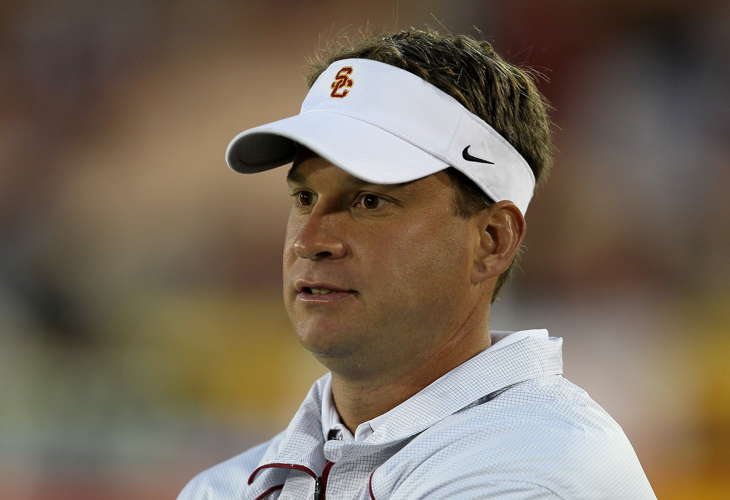 LOS ANGELES, CA - SEPTEMBER 11: Head coach Lane Kiffin watches the USC Trojans warm up for their game with the Virginia Cavaliers at Los Angeles Memorial Coliseum on September 11, 2010 in Los Angeles, California. (Photo by Stephen Dunn/Getty Images) LOS ANGELES, CA - SEPTEMBER 11: Head coach Lane Kiffin watches the USC Trojans warm up for their game with the Virginia Cavaliers at Los Angeles Memorial Coliseum on September 11, 2010 in Los Angeles, California. (Photo by Stephen Dunn/Getty Images)