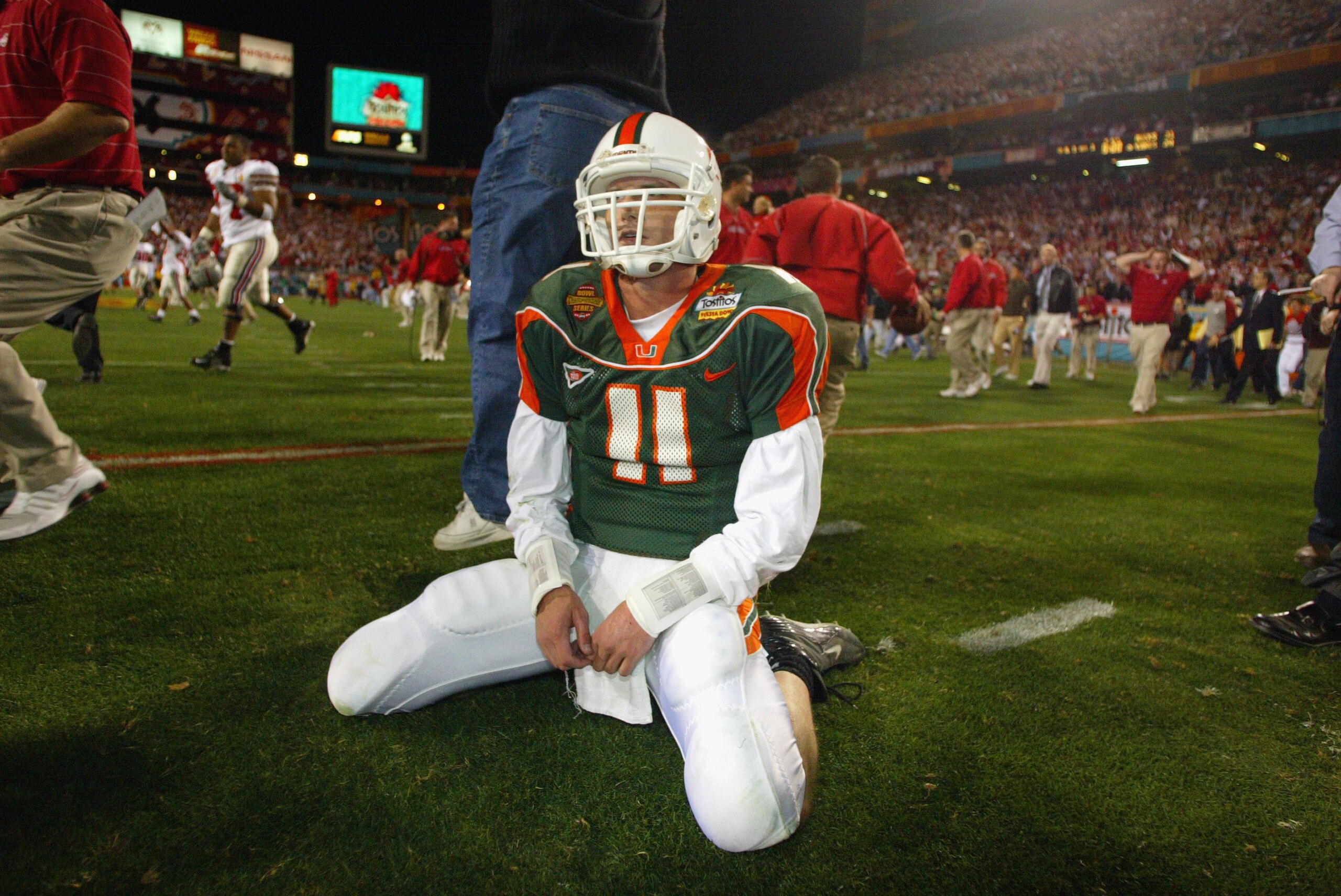 TEMPE, AZ - JANUARY 3:  Ken Dorsey #11 of the University of Miami Hurricanes sits dejected after losing the double-overtime BCS Championship game to the Ohio State Buckeyes during the Tostitos Fiesta Bowl at Sun Devil Stadium on January 3, 2003 in Tempe,