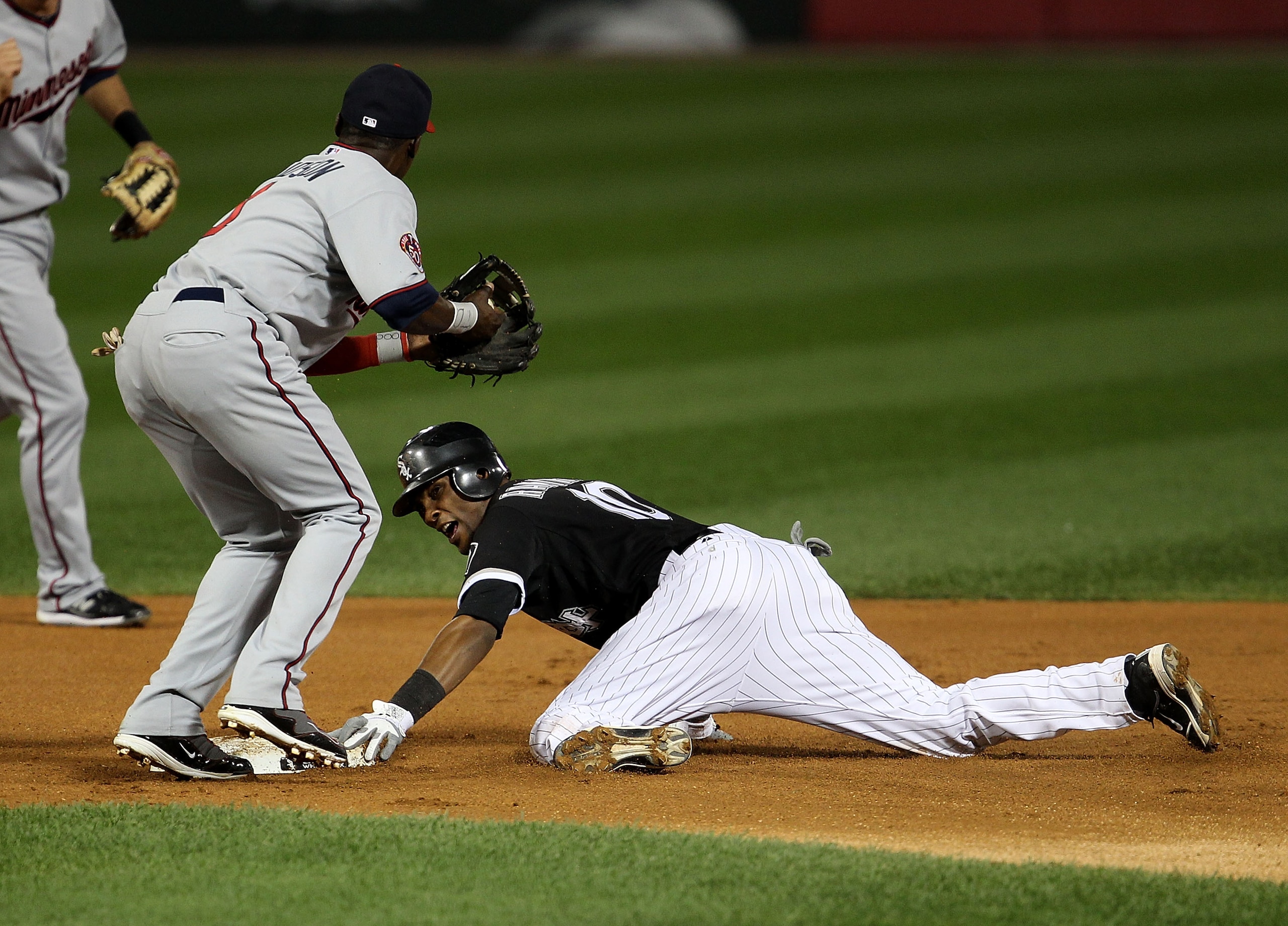 CHICAGO - SEPTEMBER 14: Alexei Ramirez #10 of the Chicago White Sox safely steals second base ahead of the tag attempt by Orlando Hudson #1 of the Minnesota Twins at U.S. Cellular Field on September 14, 2010 in Chicago, Illinois. (Photo by Jonathan Daniel