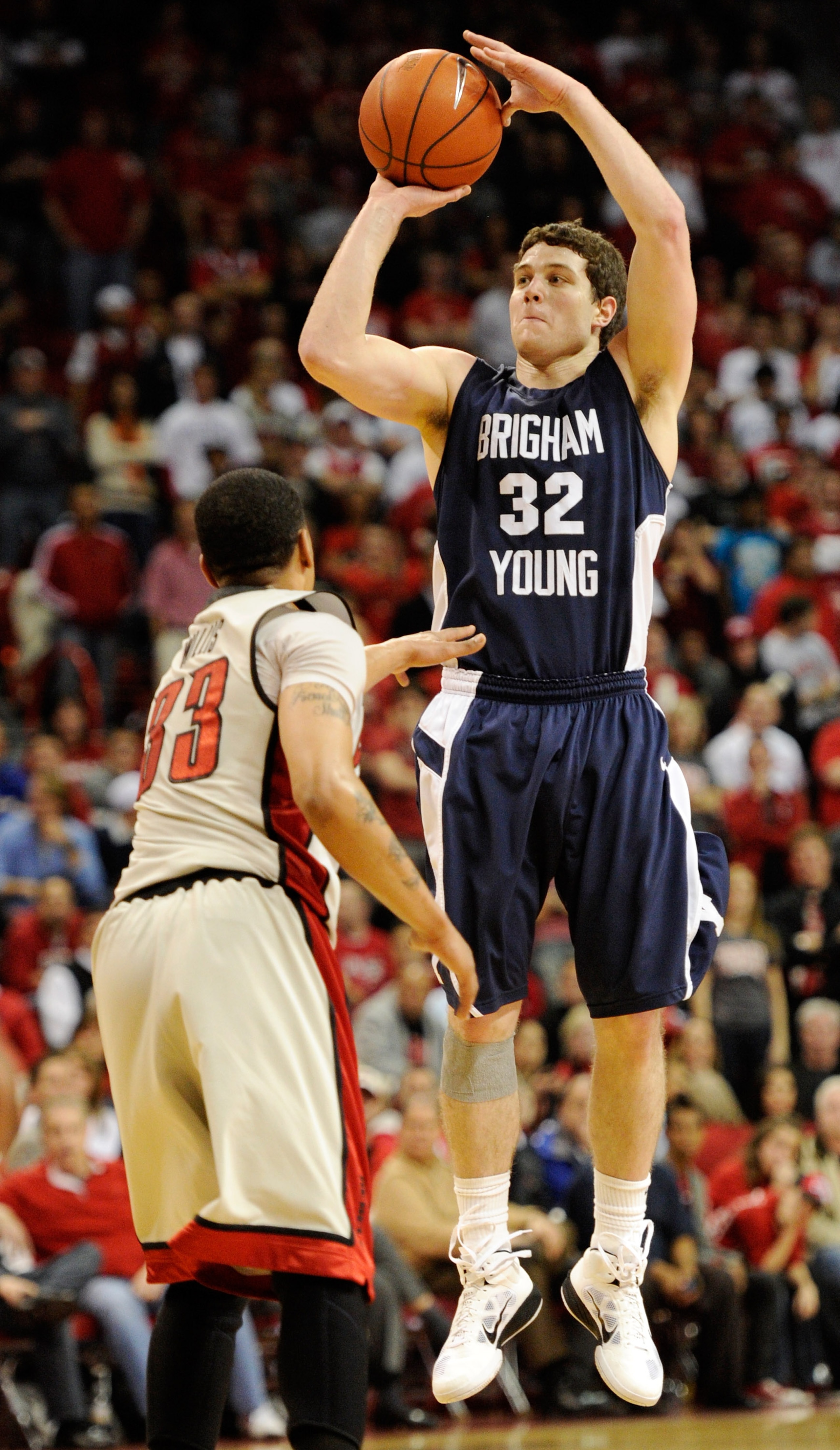 LAS VEGAS, NV - JANUARY 05: Jimmer Fredette #32 of the Brigham Young University Cougars shoots over Tre'Von Willis #33 of the UNLV Rebels during their game at the Thomas & Mack Center January 5, 2011 in Las Vegas, Nevada. BYU won 89-77. (Photo by Ethan LAS VEGAS, NV - JANUARY 05: Jimmer Fredette #32 of the Brigham Young University Cougars shoots over Tre'Von Willis #33 of the UNLV Rebels during their game at the Thomas & Mack Center January 5, 2011 in Las Vegas, Nevada. BYU won 89-77. (Photo by Ethan