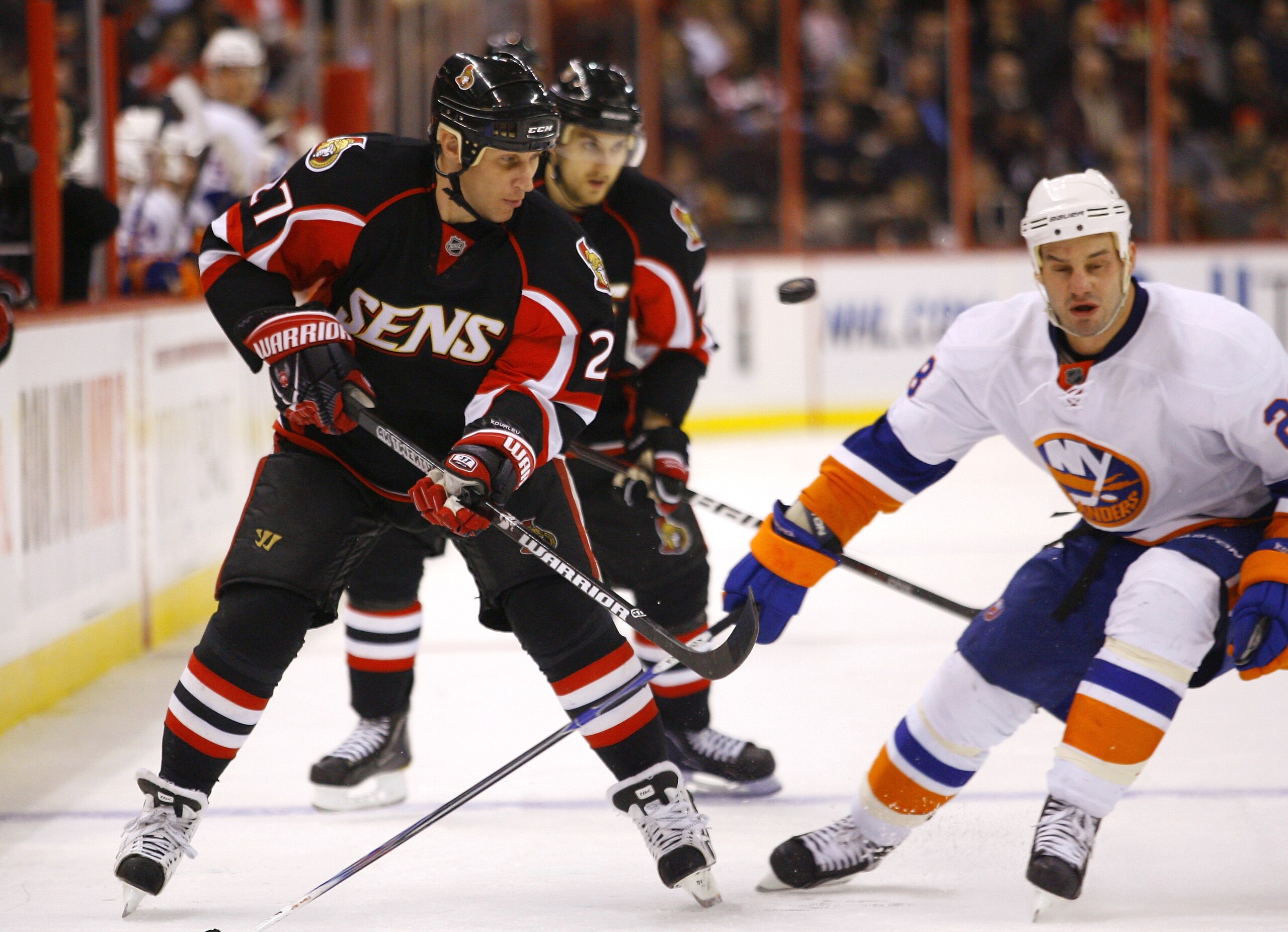 OTTAWA, ON - FEBRUARY 15:  Alex Kovalev #27 of the Ottawa Senators keeps his eyes on the puck after having it knocked off his stick by Matt Moulson #28 of the New York Islanders in a game at Scotiabank Place on February 15, 2011 in Ottawa, Canada.  (Photo
