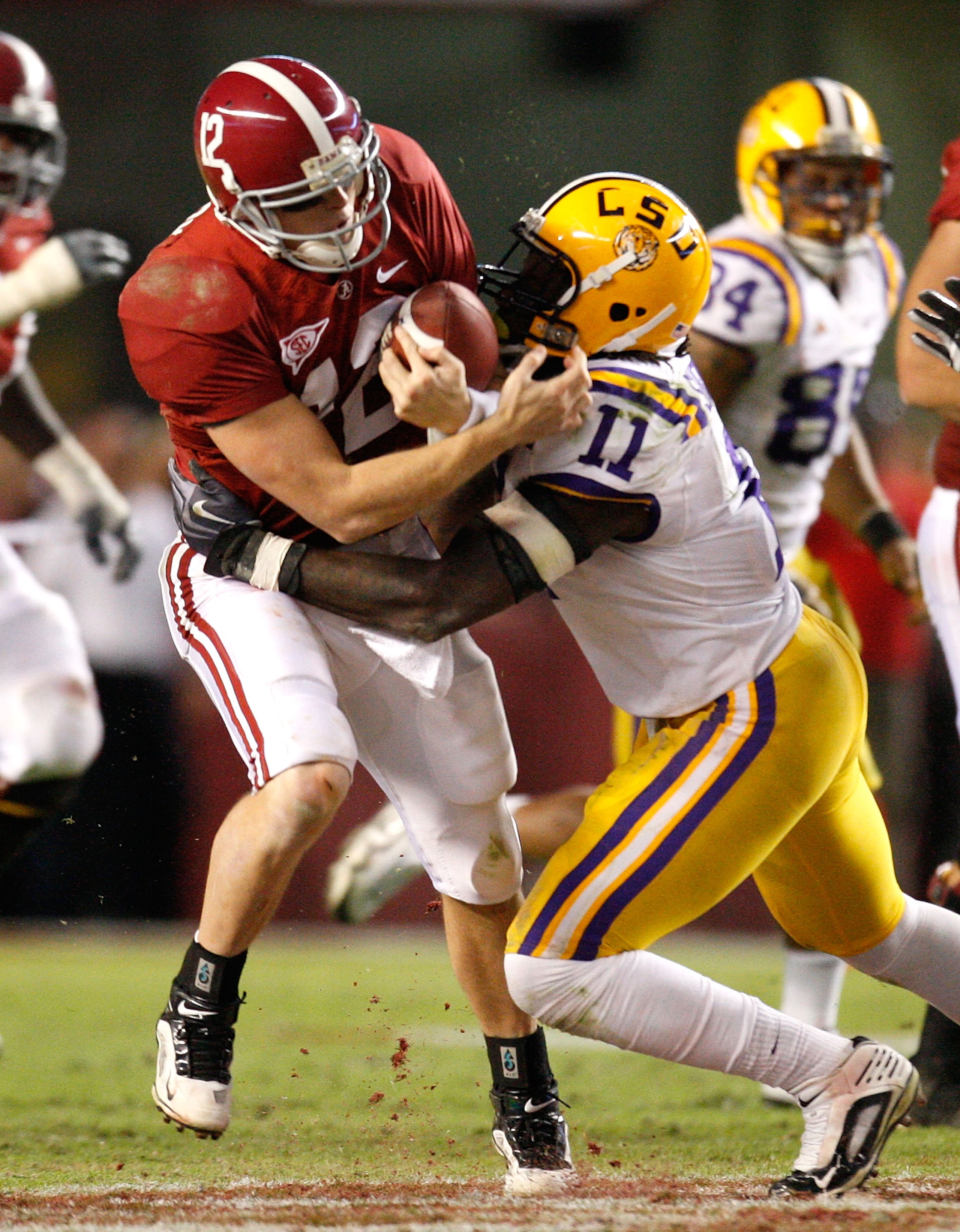 TUSCALOOSA, AL - NOVEMBER 07:  Quarterback Greg McElroy #12 of the Alabama Crimson Tide is tackled by Kelvin Sheppard #11 of the Louisiana State University Tigers at Bryant-Denny Stadium on November 7, 2009 in Tuscaloosa, Alabama.  (Photo by Kevin C. Cox/