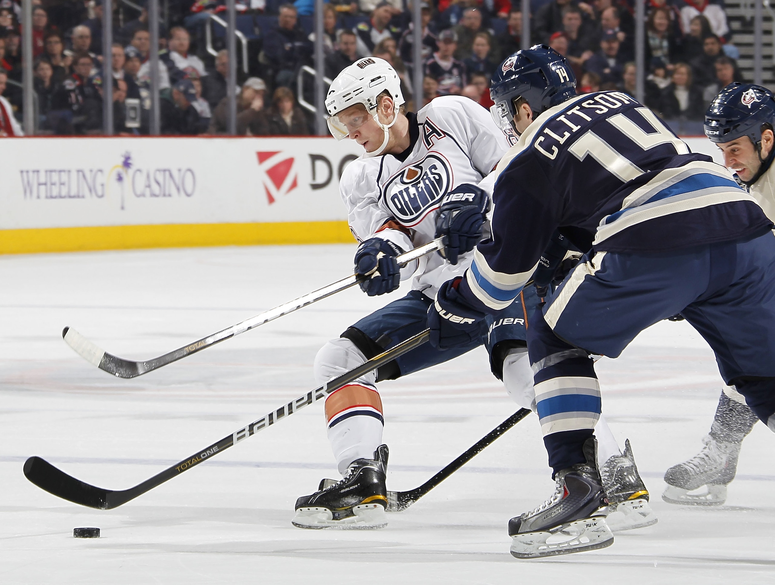 COLUMBUS, OH - FEBRUARY 05:  Ales Hemsky #83 of the Edmonton Oilers tries to control the puck behind Grant Clitsome #14 of the Columbus Blue Jackets at Nationwide Arena on February 5, 2011 in Columbus, Ohio.  (Photo by Gregory Shamus/Getty Images)