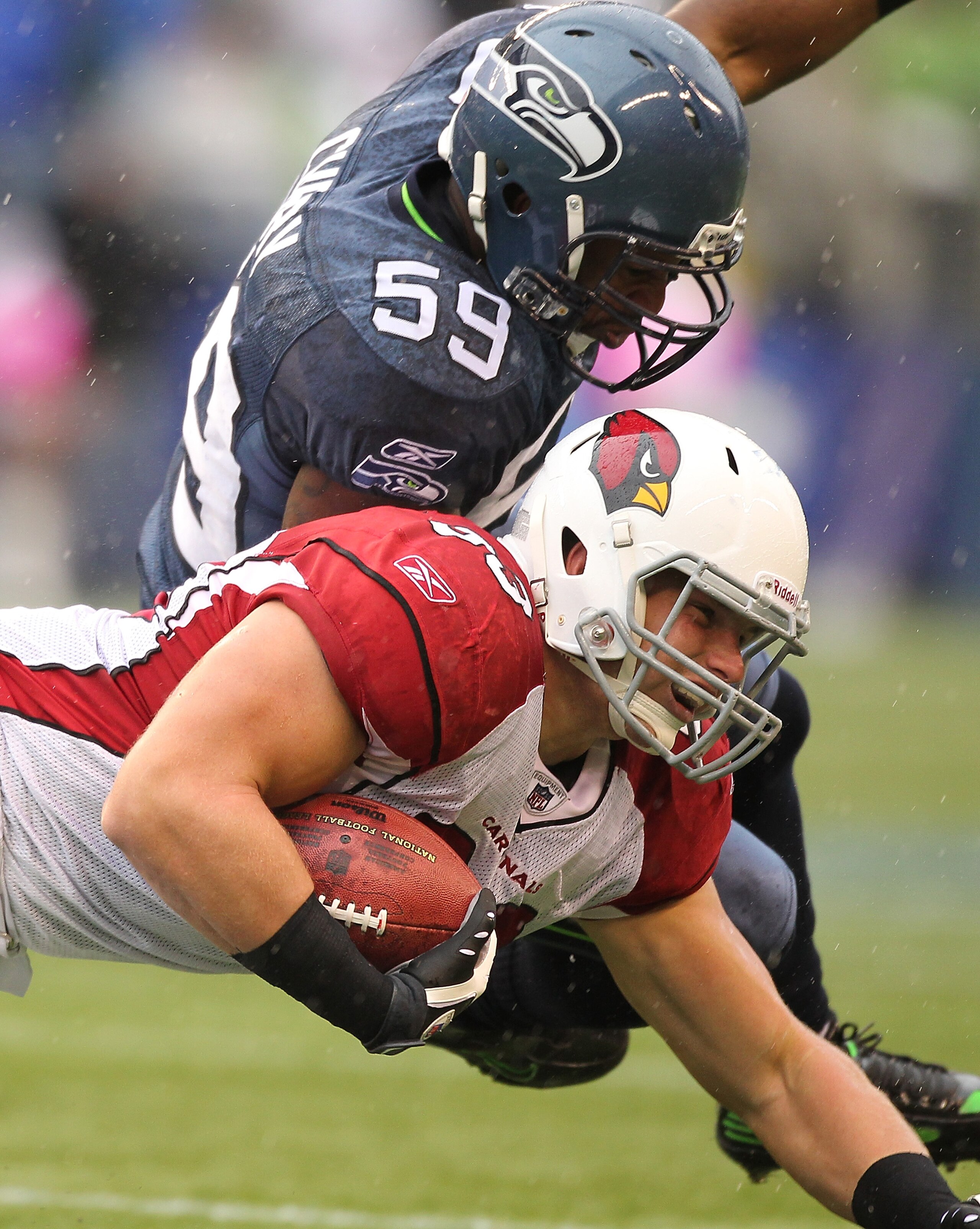 SEATTLE - OCTOBER 24:  Tight end Stephen Spach #83 of the Arizona Cardinals is tackled by Aaron Curry #59 of the Seattle Seahawks at Qwest Field on October 24, 2010 in Seattle, Washington. The Seahawks defeated the Cardinals 22-10. (Photo by Otto Greule J