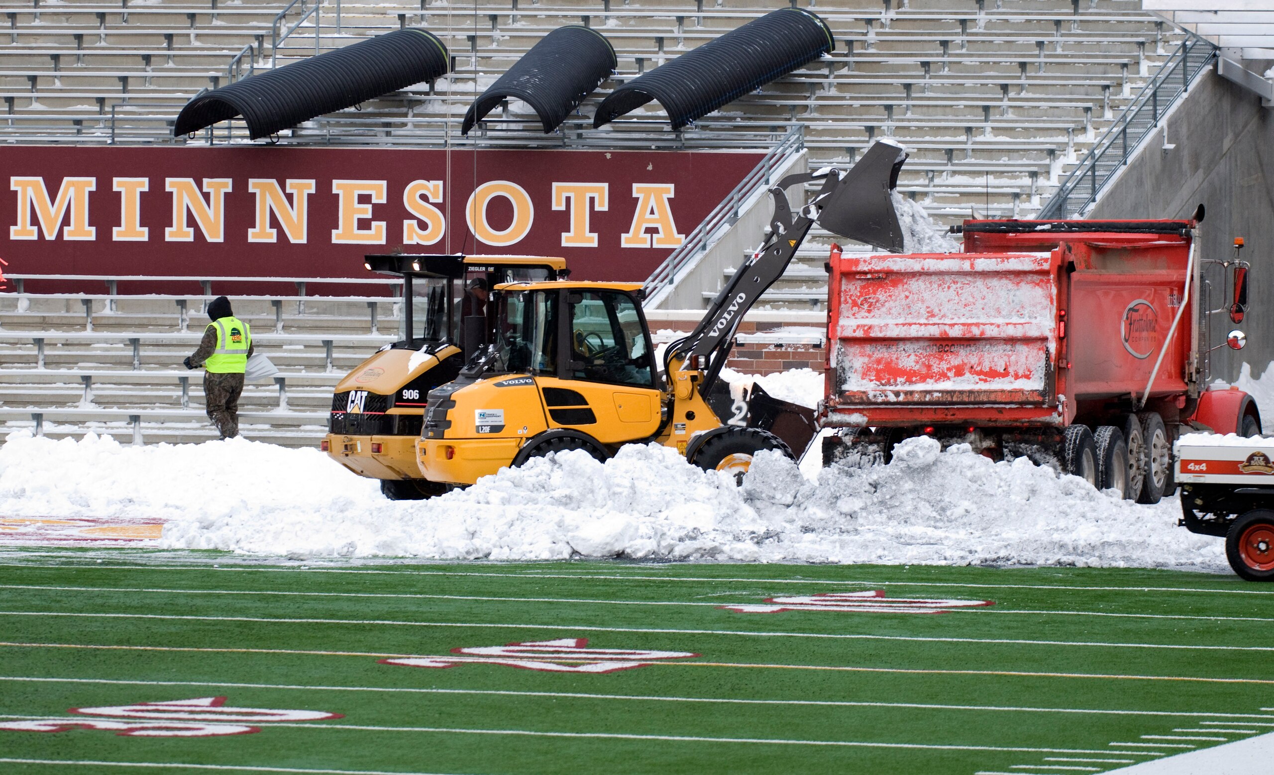 MINNEAPOLIS, MN - DECEMBER 17: Heavy machinery removes the last of the snow from the playing field as TCF Bank Stadium prepares for a potential monday night football game between the Minnesota Vikings and Chicago Bears on December 17, 2010 in Minneapolis,