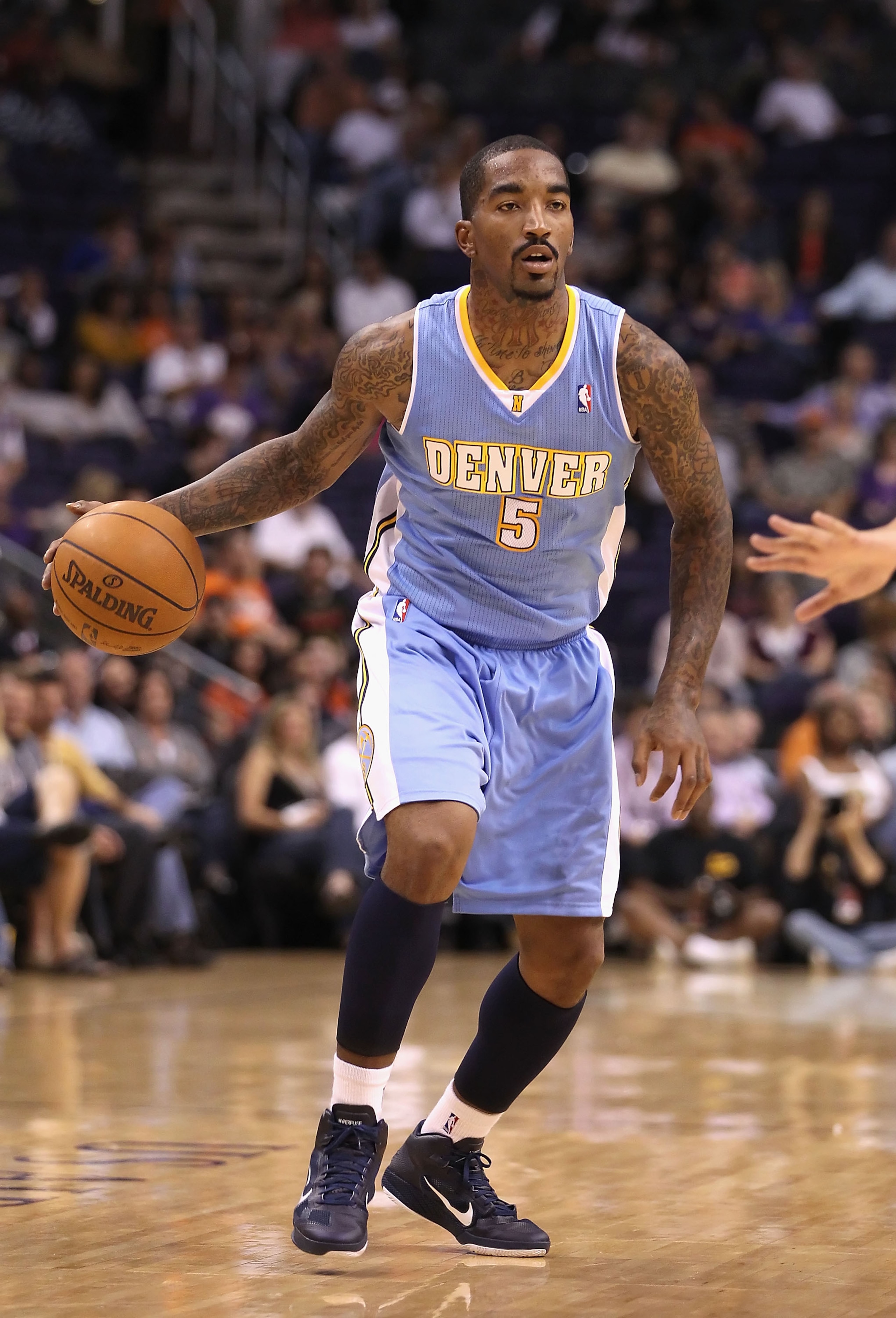 PHOENIX - OCTOBER 22:  J.R. Smith #5 of the Denver Nuggets handles the ball during the preseason NBA game against the Phoenix Suns at US Airways Center on October 22, 2010 in Phoenix, Arizona. NOTE TO USER: User expressly acknowledges and agrees that, by