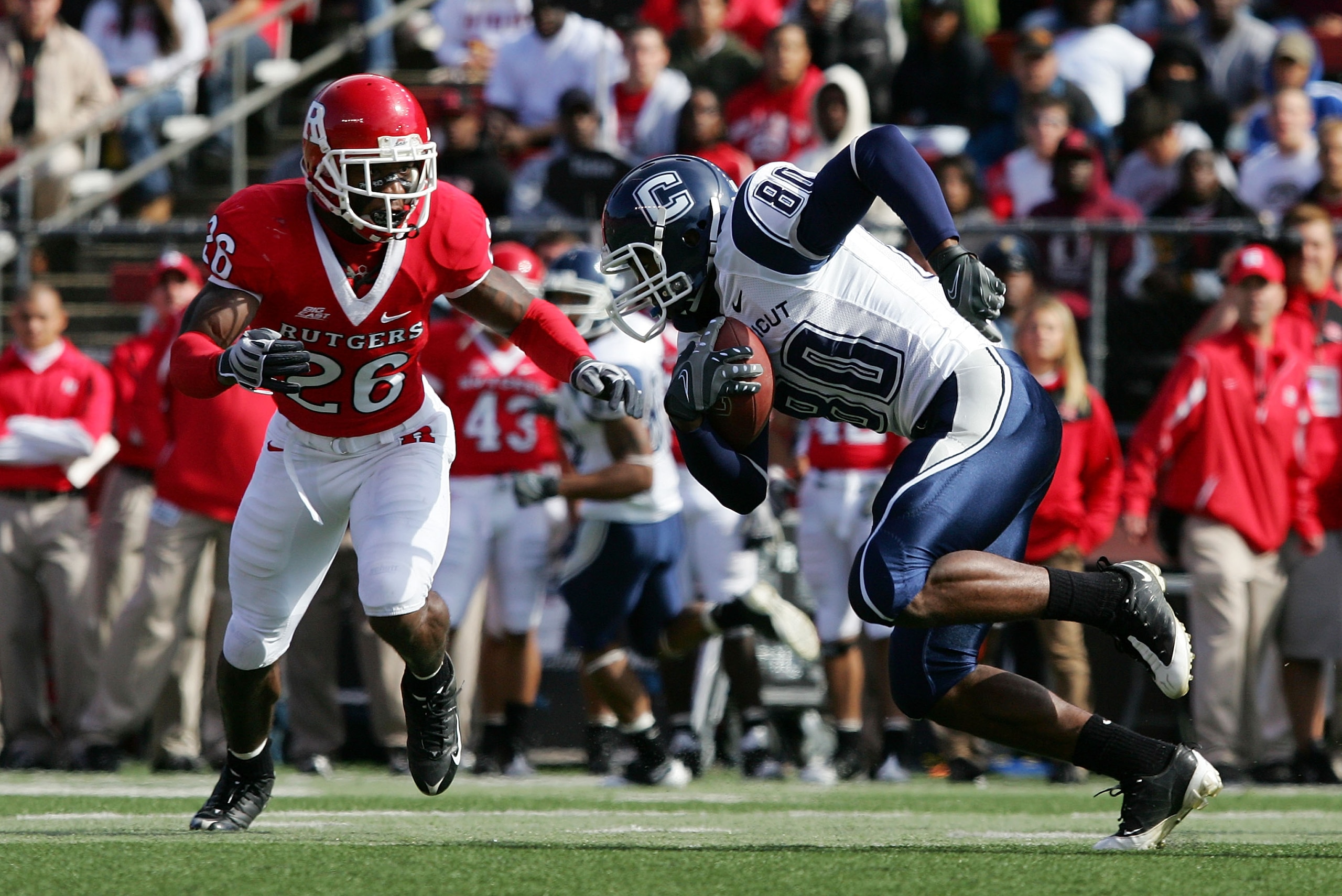 PISCATAWAY, NJ - OCTOBER 18:  Michael Smith #80 of the Connecticut Huskies runs the ball after a reception against Joe Lefeged #26 of the Rutgers Scarlet Knights at Rutgers Stadium on October 18, 2008 in Piscataway, New Jersey.  (Photo by Jim McIsaac/Gett