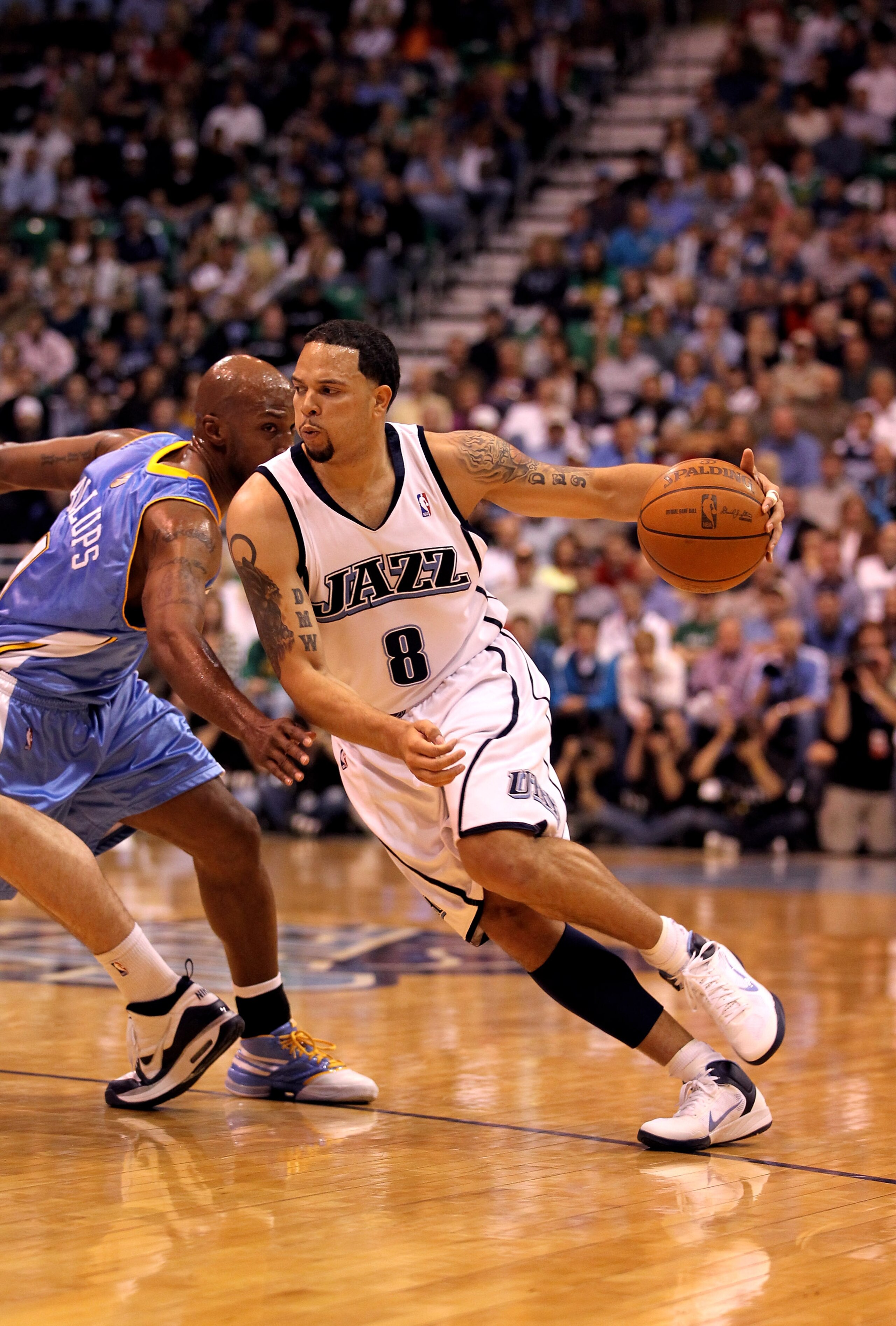 SALT LAKE CITY - APRIL 30: Deron Williams #8 of the Utah Jazz drives past Chauncey Billups #1 of the Denver Nuggets during Game Six of the Western Conference Quarterfinals of the 2010 NBA Playoffs at EnergySolutions Arena on April 30, 2010 in Salt Lake C SALT LAKE CITY - APRIL 30: Deron Williams #8 of the Utah Jazz drives past Chauncey Billups #1 of the Denver Nuggets during Game Six of the Western Conference Quarterfinals of the 2010 NBA Playoffs at EnergySolutions Arena on April 30, 2010 in Salt Lake C