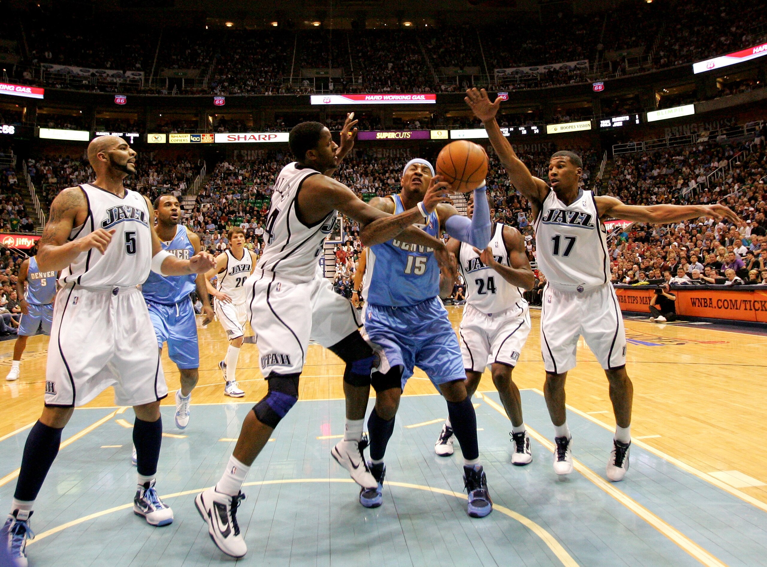 SALT LAKE CITY - APRIL 30: Carmelo Anthony #15 of the Denver Nuggets is fouled by C.J. Miles #34 of the Utah Jazz in Game Six of the Western Conference Quarterfinals of the 2010 NBA Playoffs at EnergySolutions Arena on April 30, 2010 in Salt Lake City, U SALT LAKE CITY - APRIL 30: Carmelo Anthony #15 of the Denver Nuggets is fouled by C.J. Miles #34 of the Utah Jazz in Game Six of the Western Conference Quarterfinals of the 2010 NBA Playoffs at EnergySolutions Arena on April 30, 2010 in Salt Lake City, U