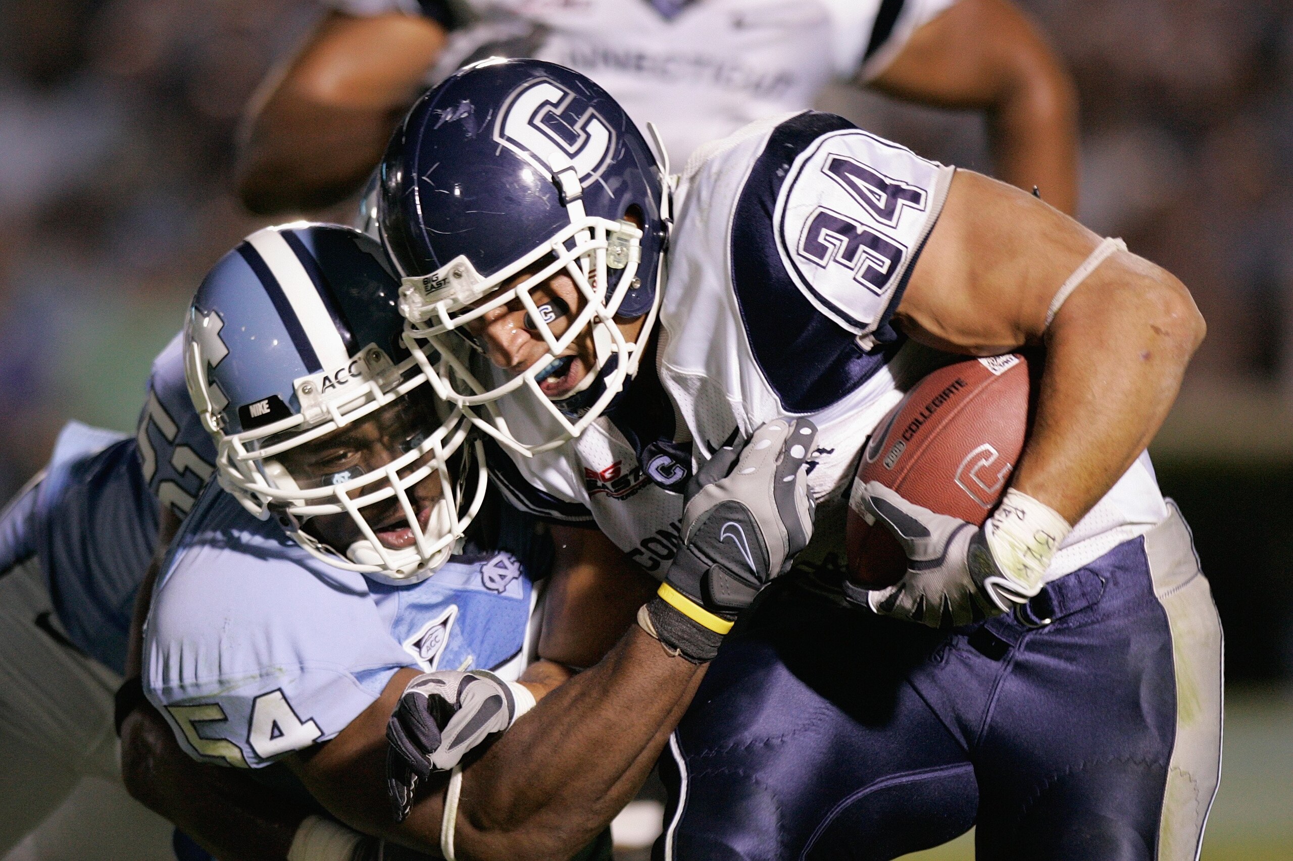 CHAPEL HILL, NC - OCTOBER 4:  Donald Brown #34 of the Connecticut Huskies carries the ball against Bruce Carter #54 of the North Carolina Tar Heels during the game at Kenan Stadium on October 4, 2008 in Chapel Hill, North Carolina.  (Photo by Kevin C. Cox