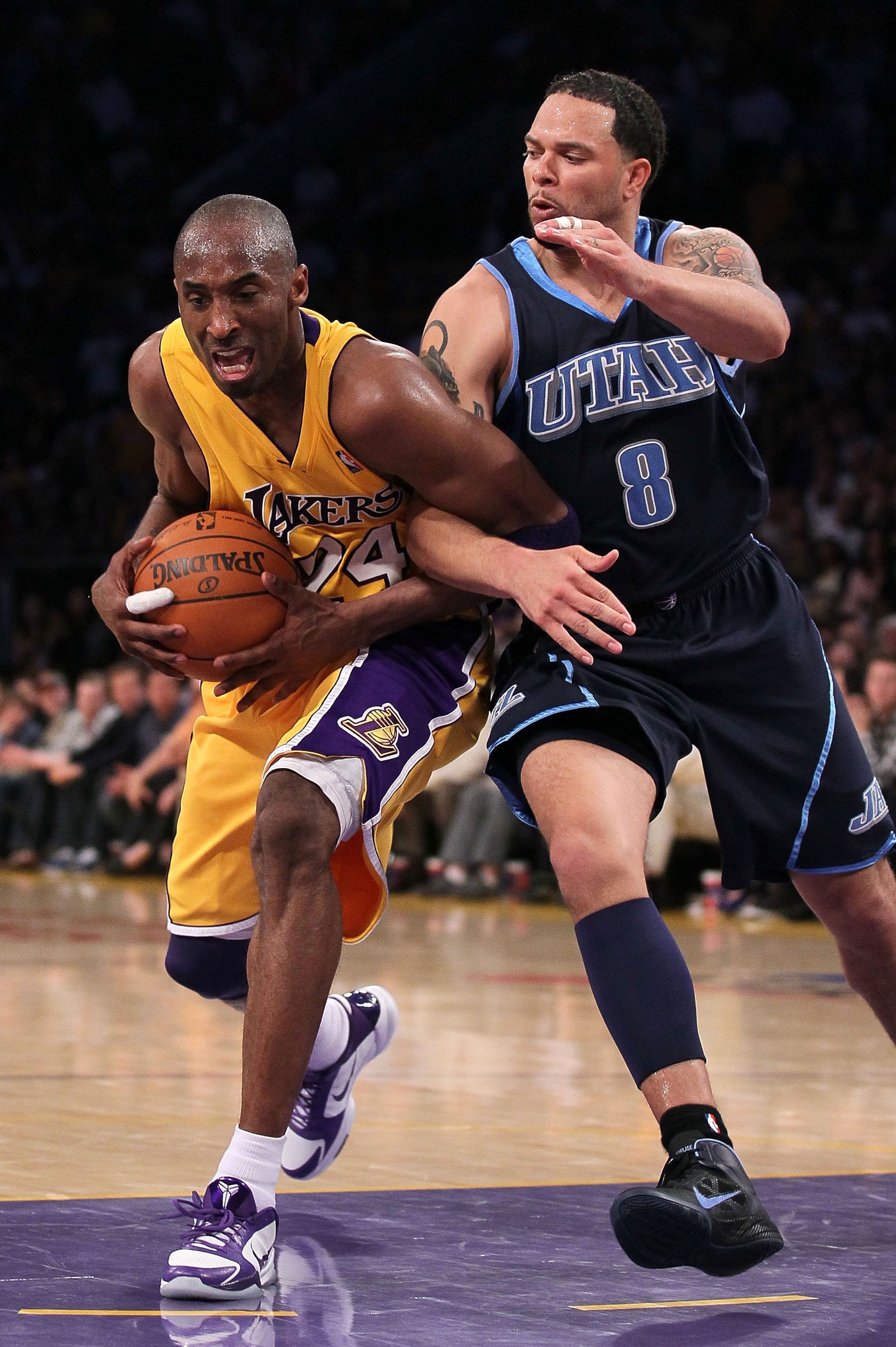 LOS ANGELES, CA - MAY 04:  Kobe Bryant #24 of the Los Angeles Lakers gets tied up with Deron Williams #8 of the Utah Jazz in the fourth quarter during Game Two of the Western Conference Semifinals of the 2010 NBA Playoffs at Staples Center on May 4, 2010