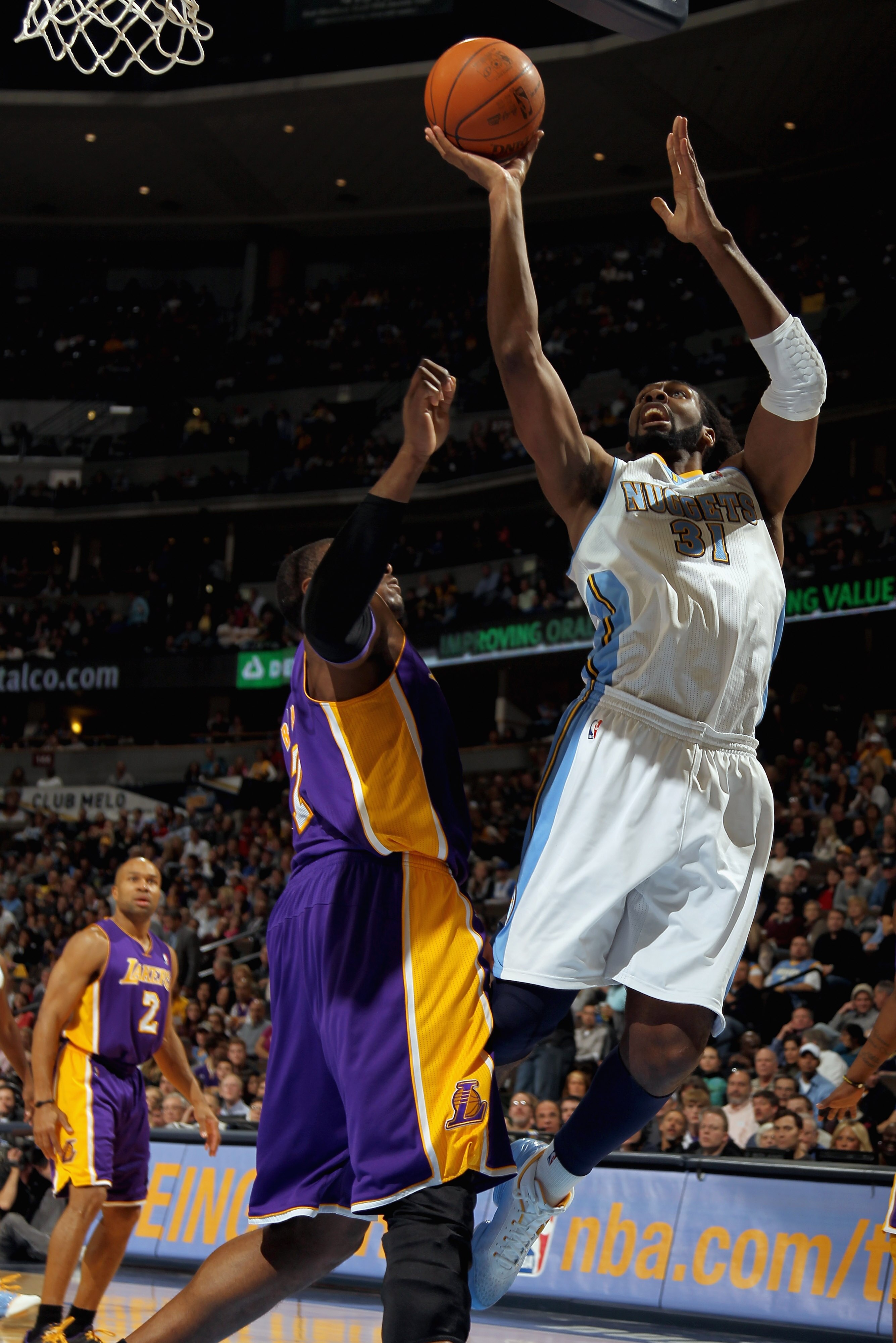 DENVER, CO - JANUARY 21:  Nene #31 of the Denver Nuggets puts up a shot against Andrew Bynum #17 of the Los Angeles Lakers at the Pepsi Center on January 21, 2011 in Denver, Colorado. The Lakers defeated the Nuggets 107-97. NOTE TO USER: User expressly ac
