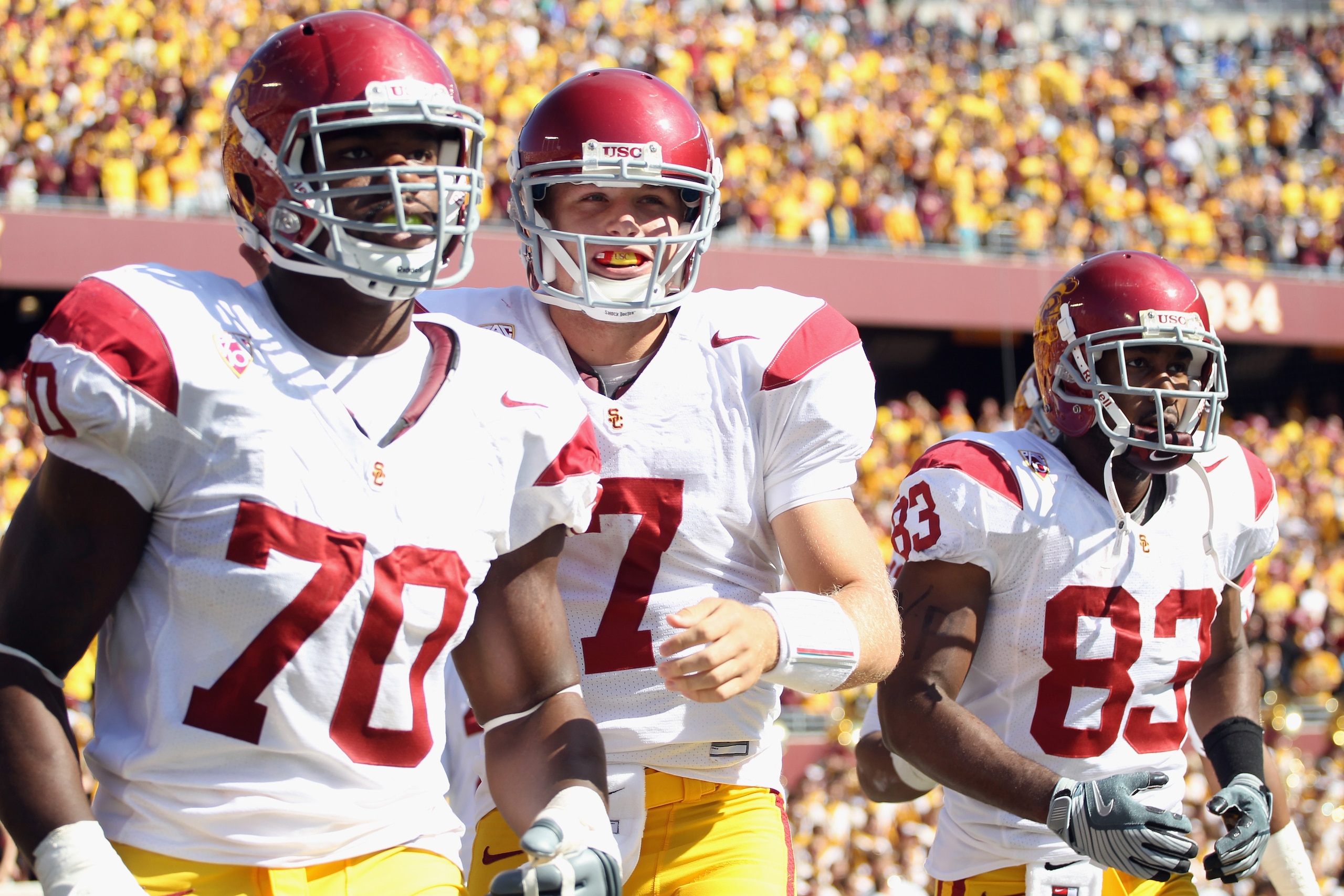 MINNEAPOLIS - SEPTEMBER 18: Quarterback Matt Barkley #7 of the USC Trojans, flanked by Tyron Smith #70 and Ronald Johnson #83, runs off the field after the Trojans scored a touchdown during the first half of the game against the Minnesota Golden Gophers MINNEAPOLIS - SEPTEMBER 18: Quarterback Matt Barkley #7 of the USC Trojans, flanked by Tyron Smith #70 and Ronald Johnson #83, runs off the field after the Trojans scored a touchdown during the first half of the game against the Minnesota Golden Gophers