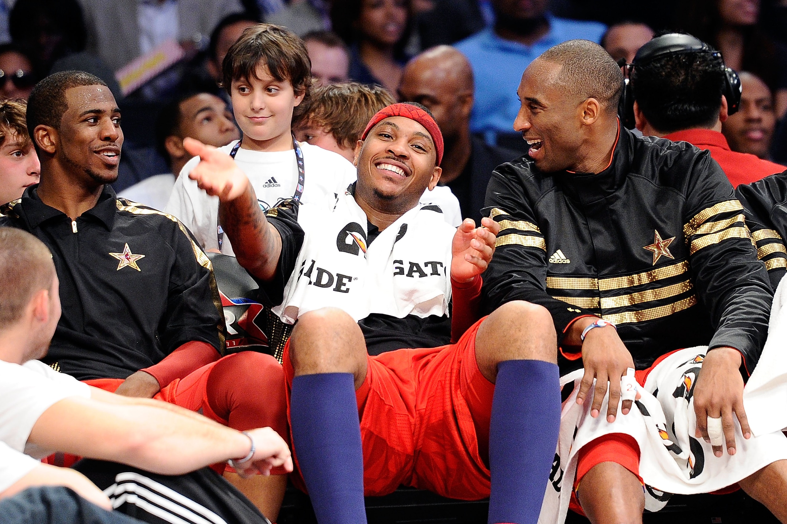 LOS ANGELES, CA - FEBRUARY 20:  (M) Carmelo Anthony #15 of the Denver Nuggets and the Western Conference reacts as he sits between Chris Paul #3 of the New Orleans Hornets and the Western Conference and Kobe Bryant #24 of the Los Angeles Lakers and the We