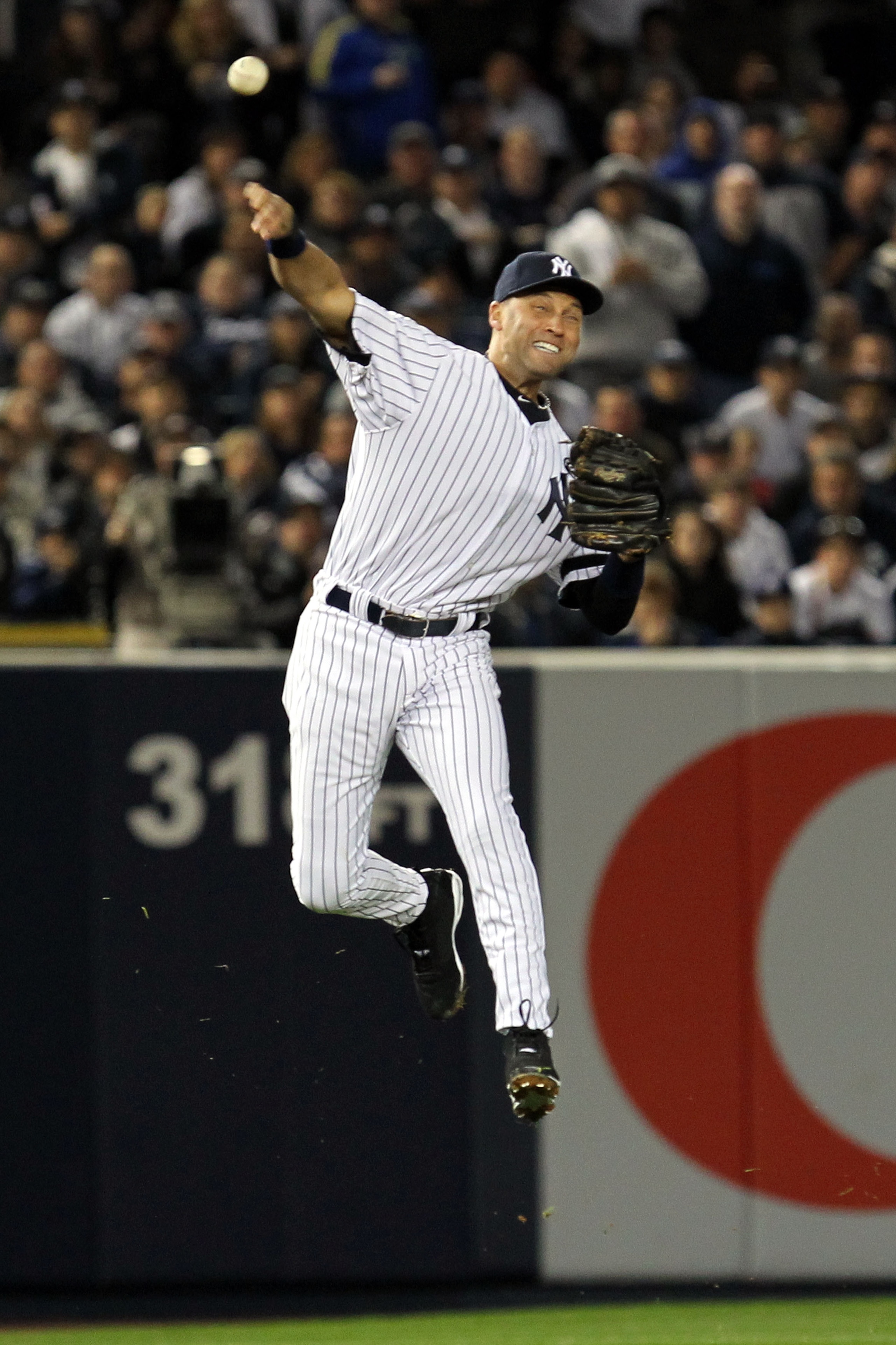 NEW YORK - OCTOBER 18: Derek Jeter #2 of the New York Yankees fails on a attempt to throw out Michael Young #10 of the Texas Rangers on an infield single in the top of the third inning of Game Three of the ALCS during the 2010 MLB Playoffs at Yankee Stad NEW YORK - OCTOBER 18: Derek Jeter #2 of the New York Yankees fails on a attempt to throw out Michael Young #10 of the Texas Rangers on an infield single in the top of the third inning of Game Three of the ALCS during the 2010 MLB Playoffs at Yankee Stad