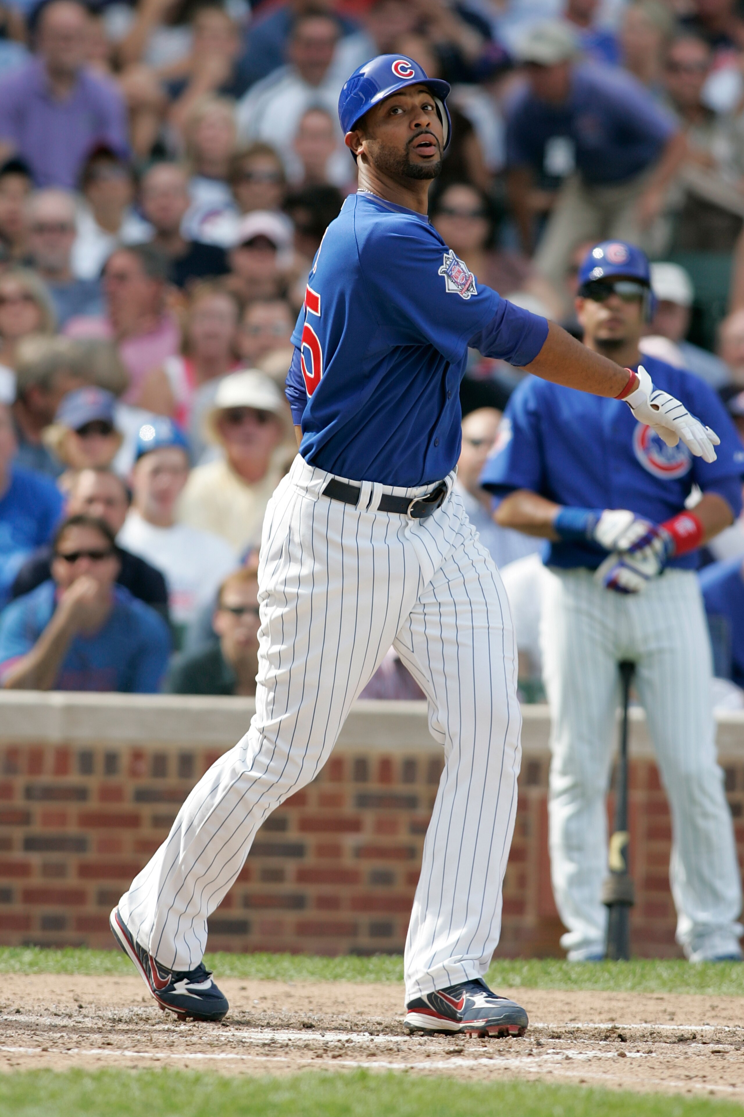 CHICAGO, IL - SEPTEMBER 19: First baseman Derrek Lee #25 of the Chicago Cubs follows through on his swing against the St. Louis Cardinals at Wrigley Field on September 19, 2008 in Chicago, Illinois. (Photo by Scott Boehm/Getty Images) CHICAGO, IL - SEPTEMBER 19: First baseman Derrek Lee #25 of the Chicago Cubs follows through on his swing against the St. Louis Cardinals at Wrigley Field on September 19, 2008 in Chicago, Illinois. (Photo by Scott Boehm/Getty Images)