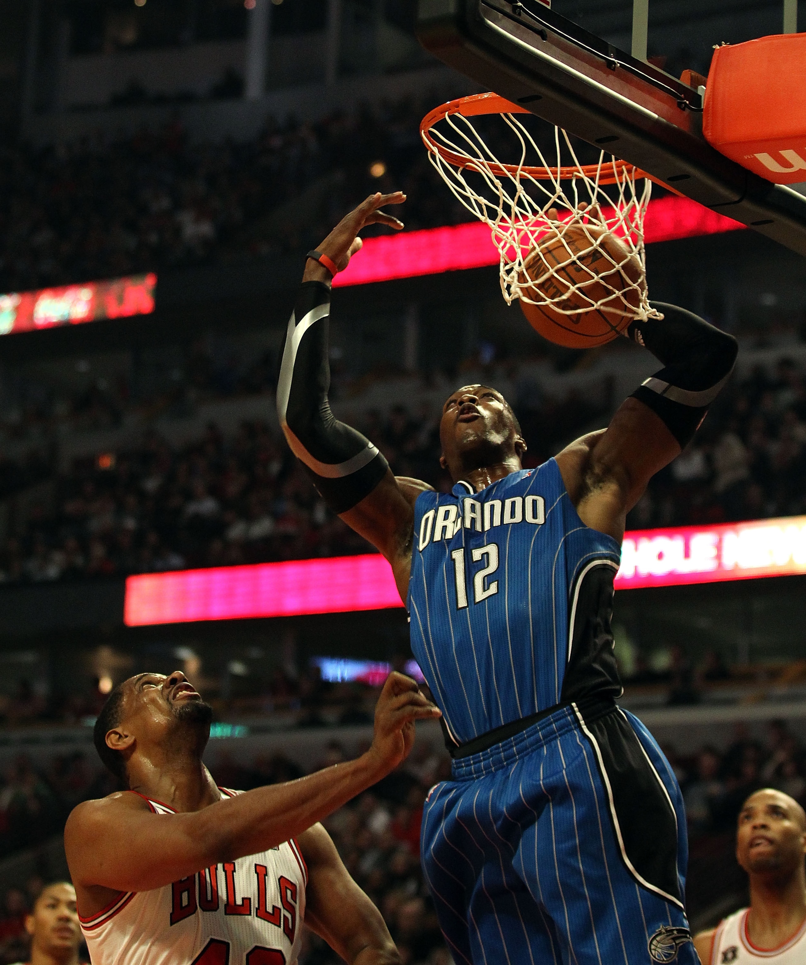 CHICAGO, IL - JANUARY 28: Dwight Howard #12 of the Orlando Magic dunks the ball over Kurt Thomas #40 of the Chicago Bulls at the United Center on January 28, 2011 in Chicago, Illinois. NOTE TO USER: User expressly acknowledges and agrees that, by download