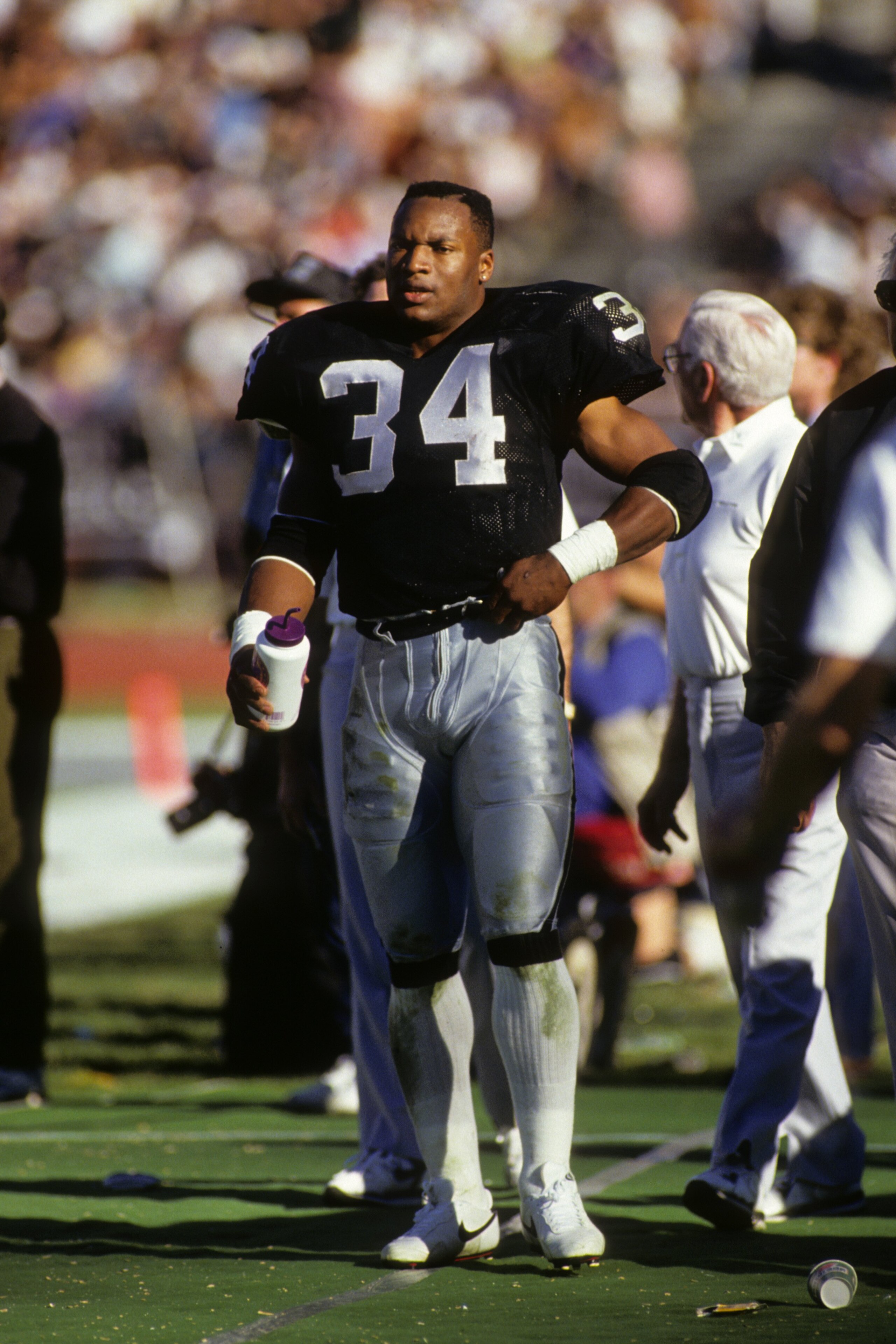 LOS ANGELES - JANUARY 13:  Running back Bo Jackson #34 of Los Angeles Raiders stands on the sidelines during the 1990 AFC Divisional Playoffs against the Cincinnati Bengals at the Los Angeles Memorial Coliseum on January 13, 1991 in Los Angeles, Californi