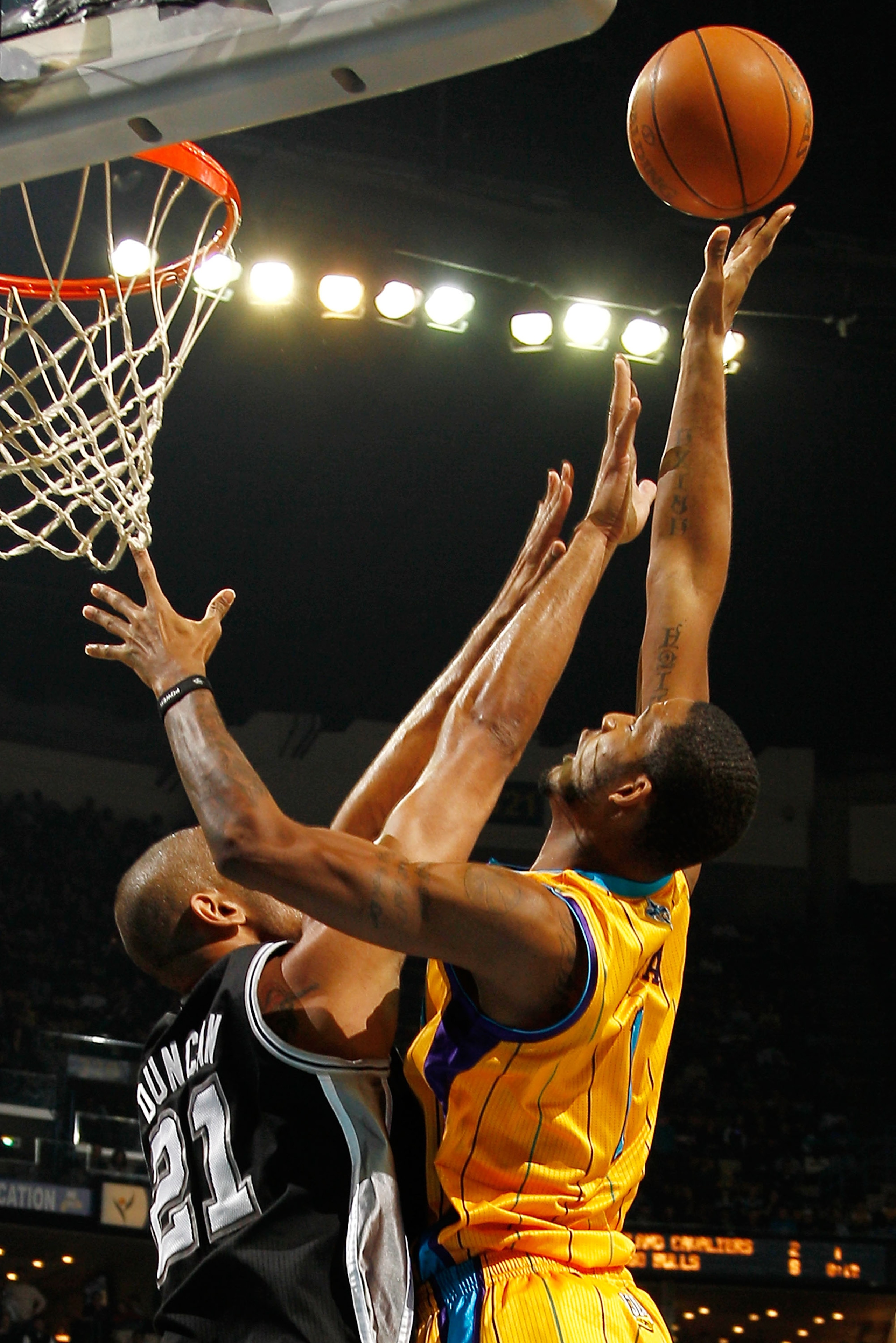 NEW ORLEANS, LA - JANUARY 22:  Trevor Ariza #1 of the New Orleans Hornets shoots the ball over Tim Duncan #21 of the San Antonio Spurs at the New Orleans Arena on January 22, 2011 in New Orleans, Louisiana.  The Hornets defeated the Spurs 96-72.  NOTE TO