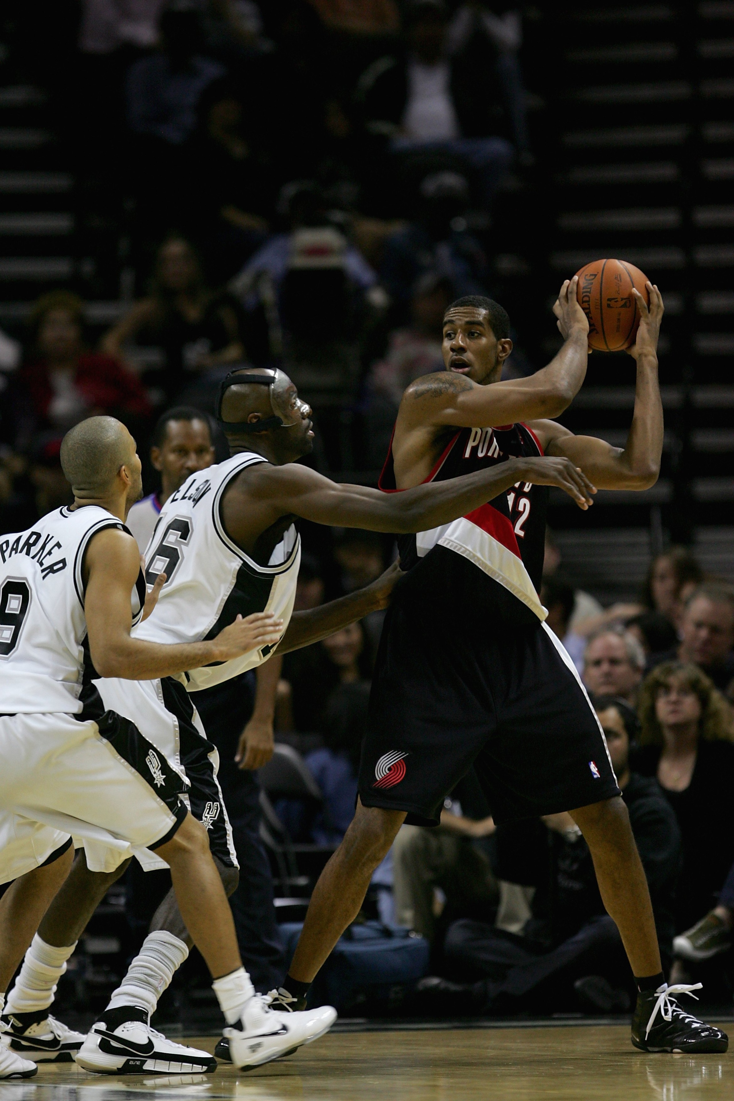 SAN ANTONIO - OCTOBER 30:  LaMarcus Aldridge #12 of the Portland Trail Blazers looks for an open pass over Francisco Elson #16 of the San Antonio Spurs during the game on October 30, 2007 at AT&T Center in San Antonio, Texas.  NOTE TO USER: User expressly