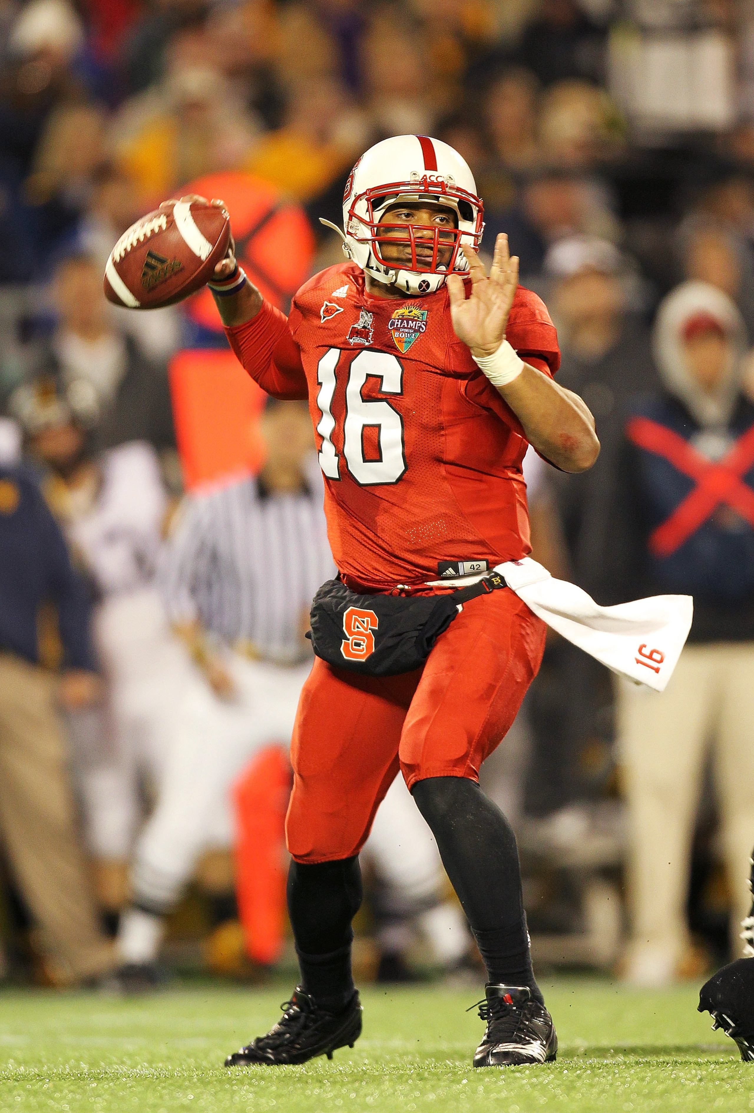 ORLANDO, FL - DECEMBER 28: Russell Wilson #16 of the North Carolina State Wolfpack passes the ball during the Champs Sports Bowl against the West Virginia Mountineers at Florida Citrus Bowl Stadium on December 28, 2010 in Orlando, Florida. (Photo by Mik ORLANDO, FL - DECEMBER 28: Russell Wilson #16 of the North Carolina State Wolfpack passes the ball during the Champs Sports Bowl against the West Virginia Mountineers at Florida Citrus Bowl Stadium on December 28, 2010 in Orlando, Florida. (Photo by Mik