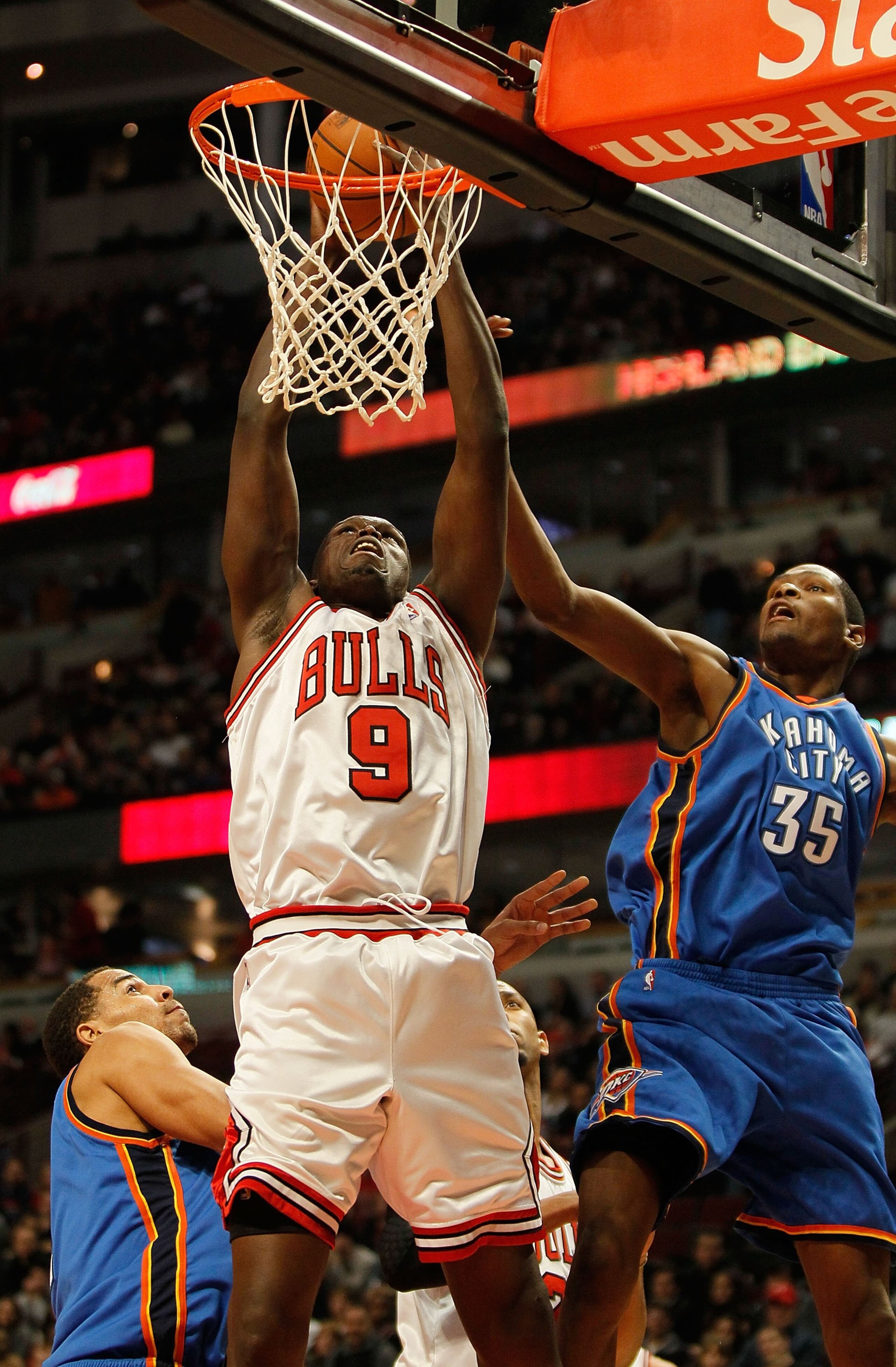 CHICAGO - JANUARY 04: Loul Deng #9 of the Chicago Bulls is fouled while shooting by Kevin Durant #35 of the Oklahoma City Thunder at the United Center on January 4, 2010 in Chicago, Illinois. The Thunder defeated the Bulls 98-85. NOTE TO USER: User expres