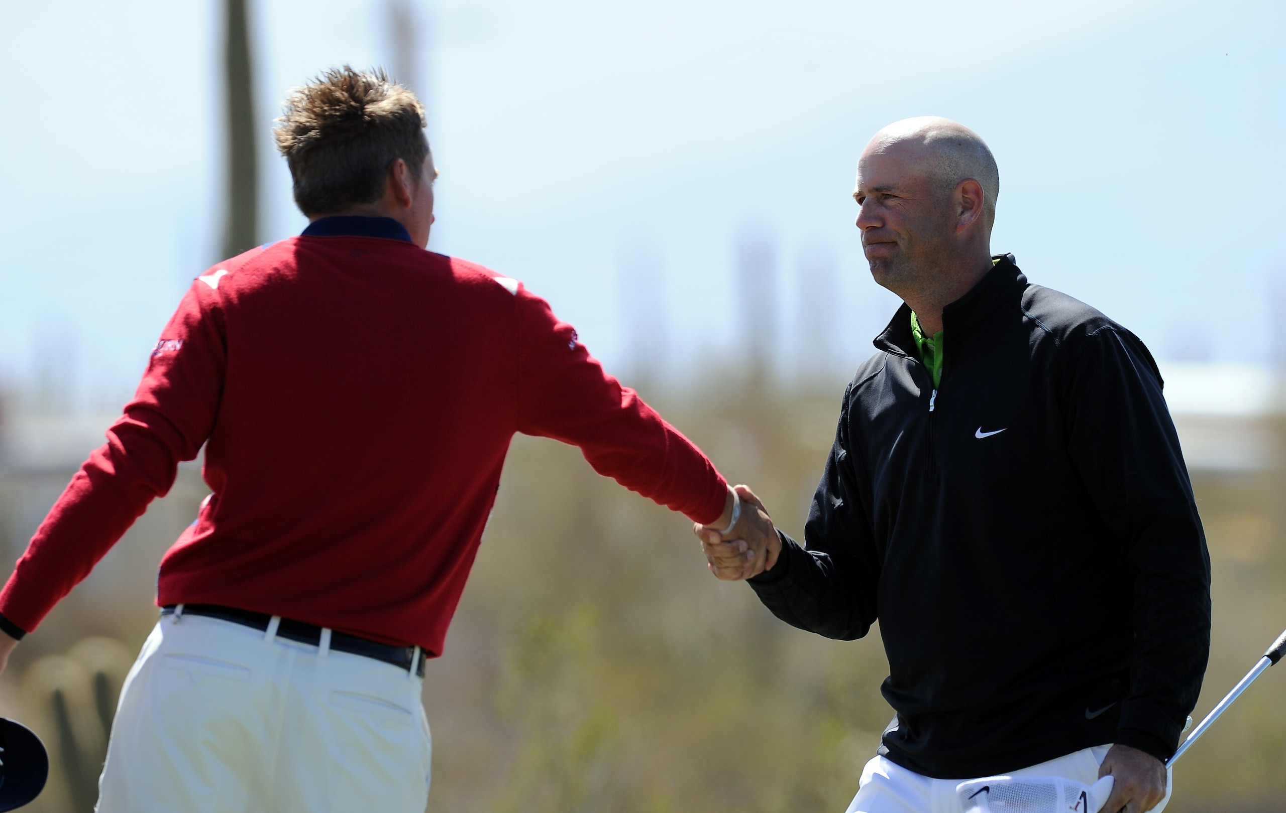 MARANA, AZ - FEBRUARY 23:  Ian Poulter of England congralutates Stewart Cink on the first extra hole of their match during the first round of the World Golf Championships-Accenture Match Play Championship held at The Ritz-Carlton Golf Club, Dove Mountain
