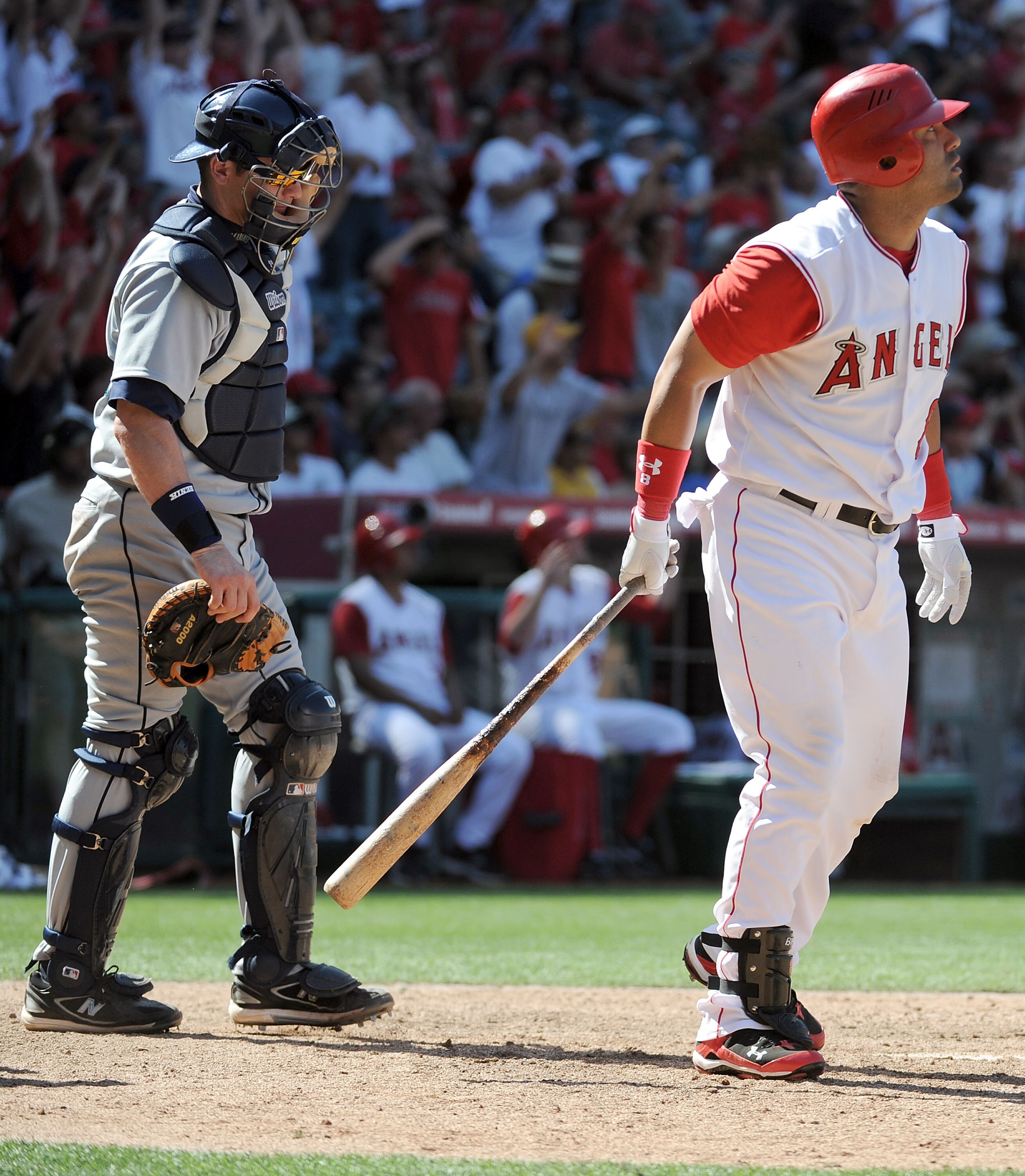 ANAHEIM, CA - MAY 29:  Kendry Morales #8 of the Los Angeles Angels watches his grand slam homerun to win the game 5-1 in front of Rob Johnson #32 of the Seattle Mariners during the bottom of the ninth inning at Angel Stadium on May 29, 2010 in Anaheim, Ca
