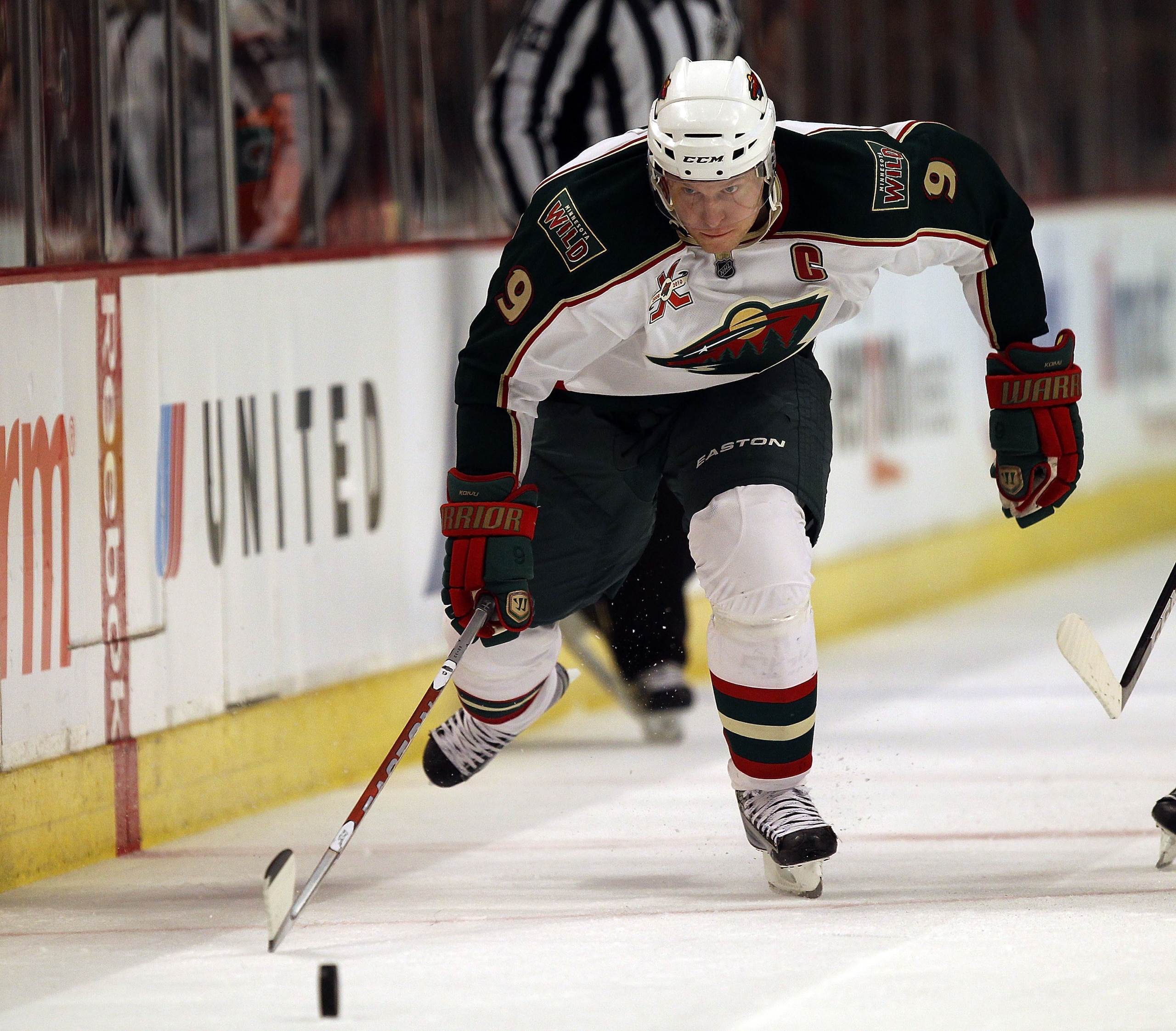 CHICAGO, IL - FEBRUARY 16: Mikko Koivu #9 of the Minnesota Wild chases down the puck against the Chicago Blackhawks at the United Center on February 16, 2011 in Chicago, Illinois. The Blackhawks defeated the Wild 3-1. (Photo by Jonathan Daniel/Getty Image