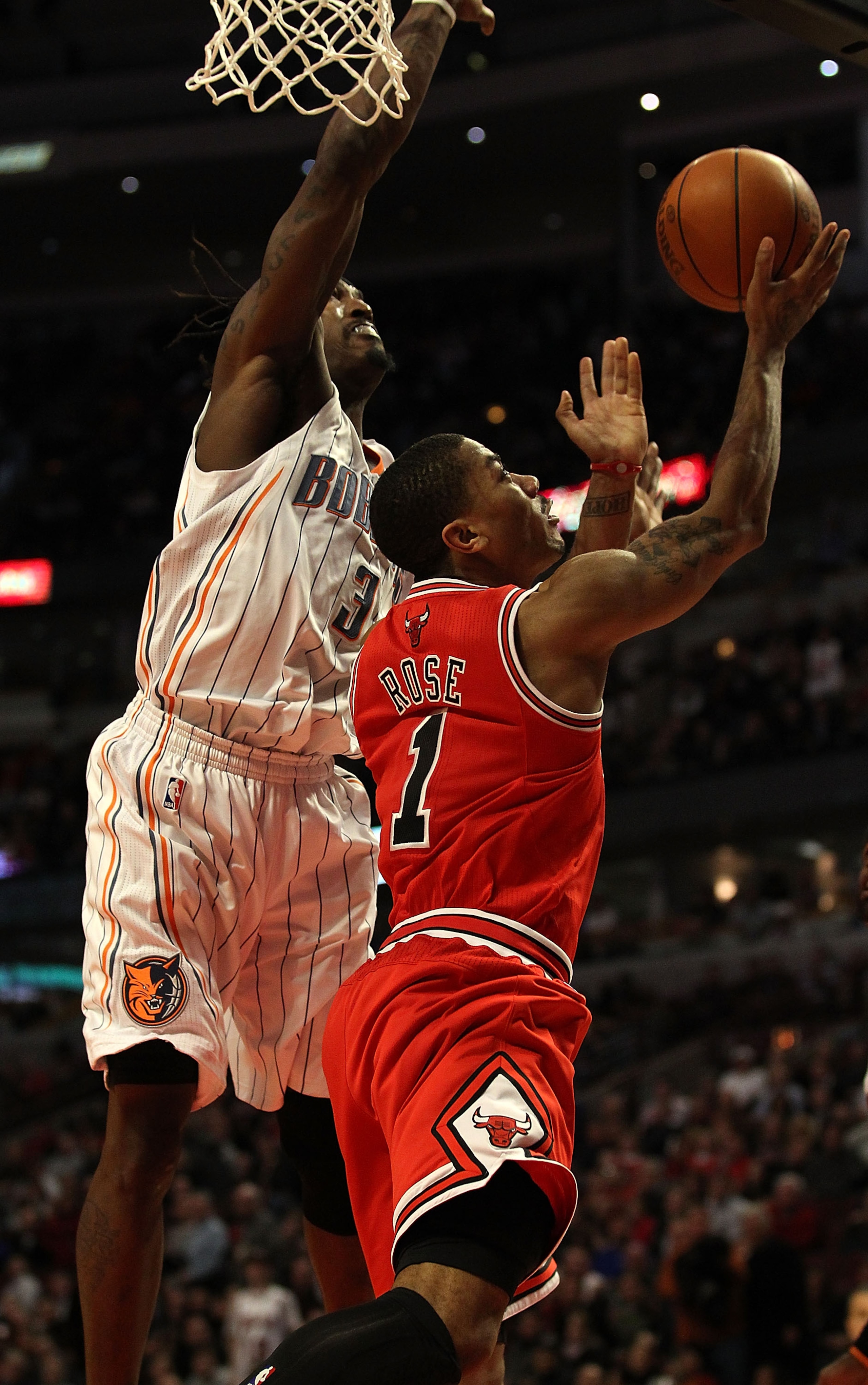 CHICAGO, IL - FEBRUARY 15: Derrick Rose #1 of the Chicago Bulls goes up for a shot against Gerald Wallace #3 of the Charlotte Bobcats at the United Center on February 15, 2011 in Chicago, Illinois. The Bulls defeated the Bobcats 106-94. NOTE TO USER: User