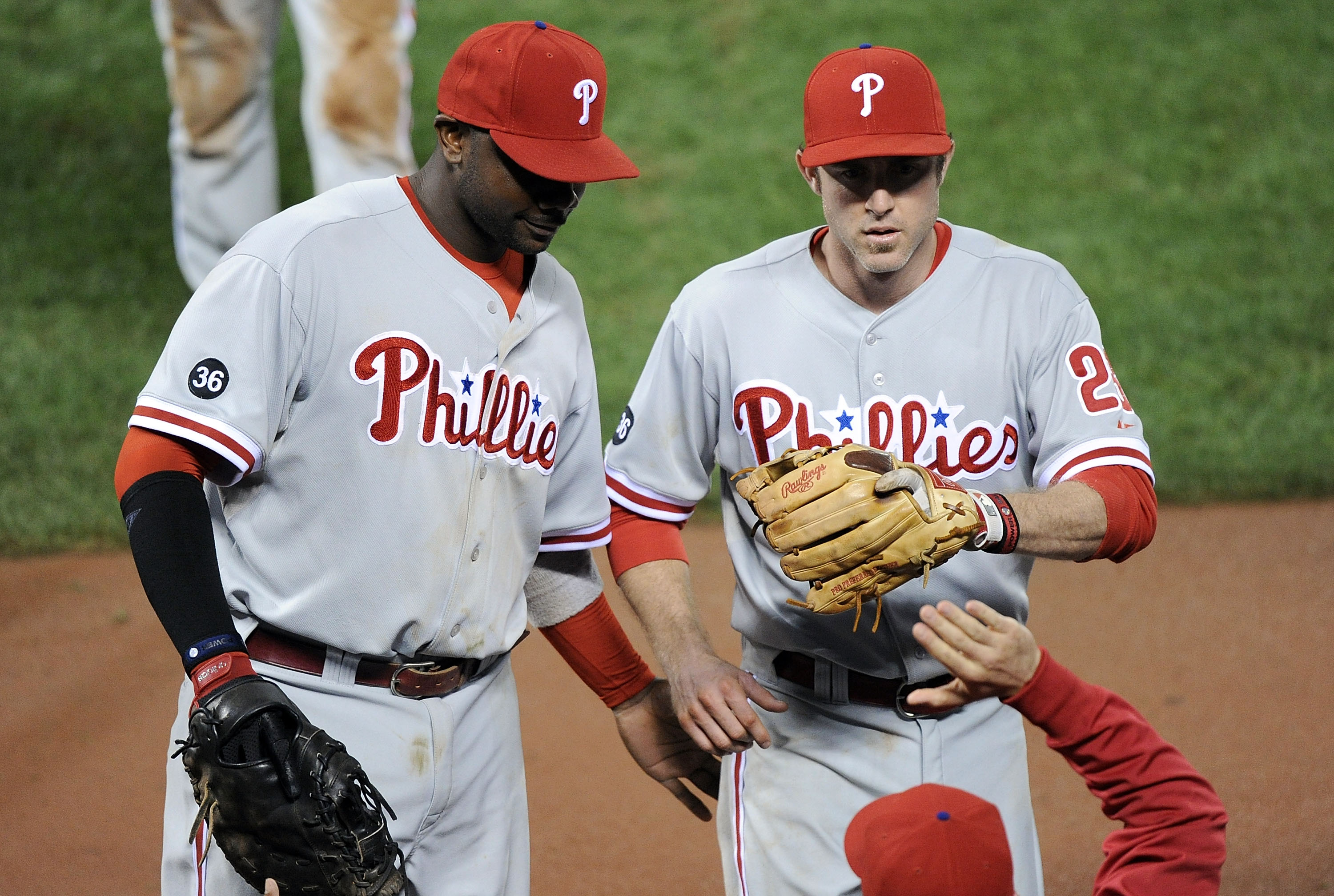 Philadelphia Phillies Chase Utley, center, is congratulated by