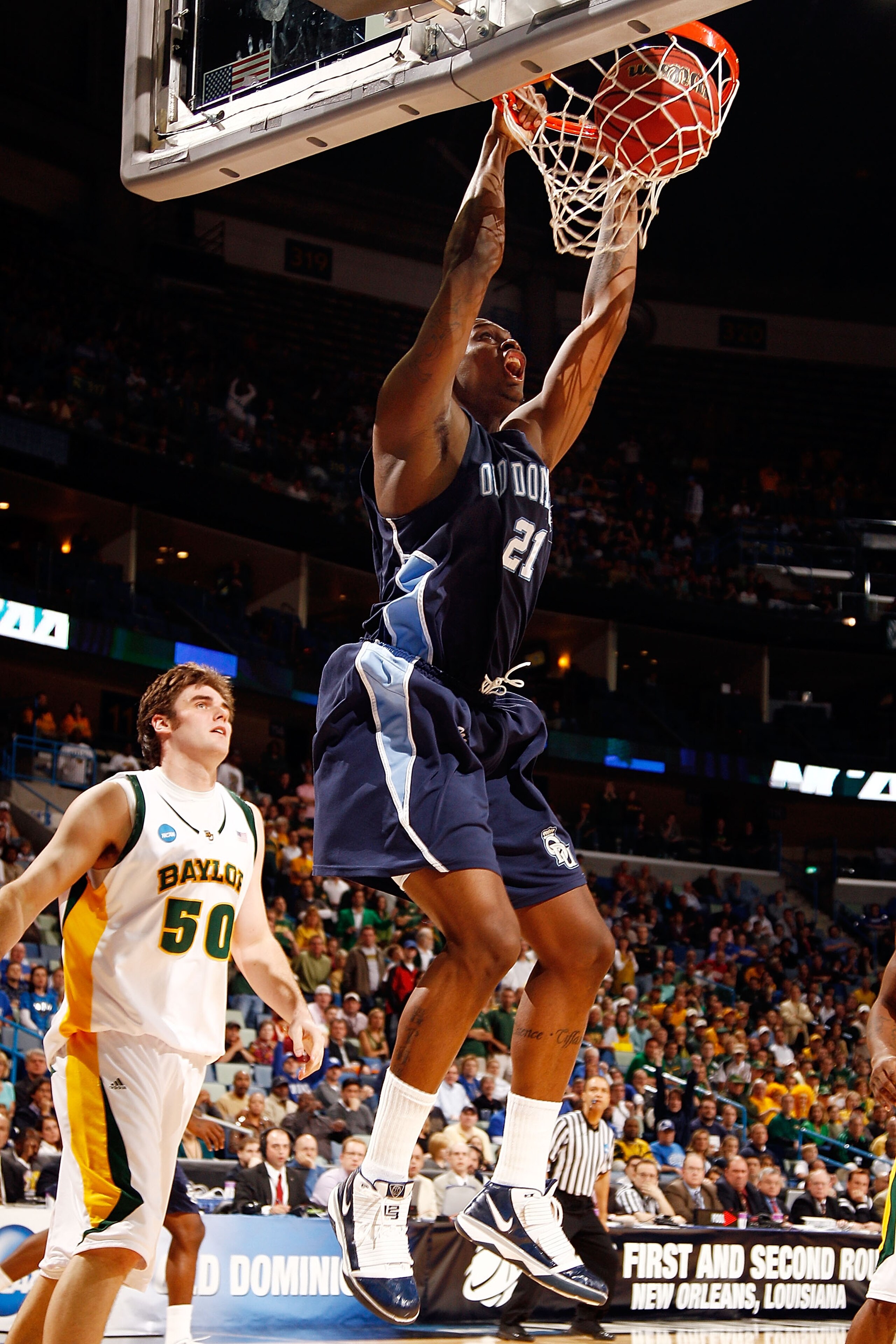 NEW ORLEANS - MARCH 20:  Frank Hassell #21 of the Old Dominion University Monarchs dunks the ball over Josh Lomers #50 of the Baylor Bears during the second round of the 2010 NCAA men's basketball tournament at the New Orleans Arena on March 20, 2010 in N