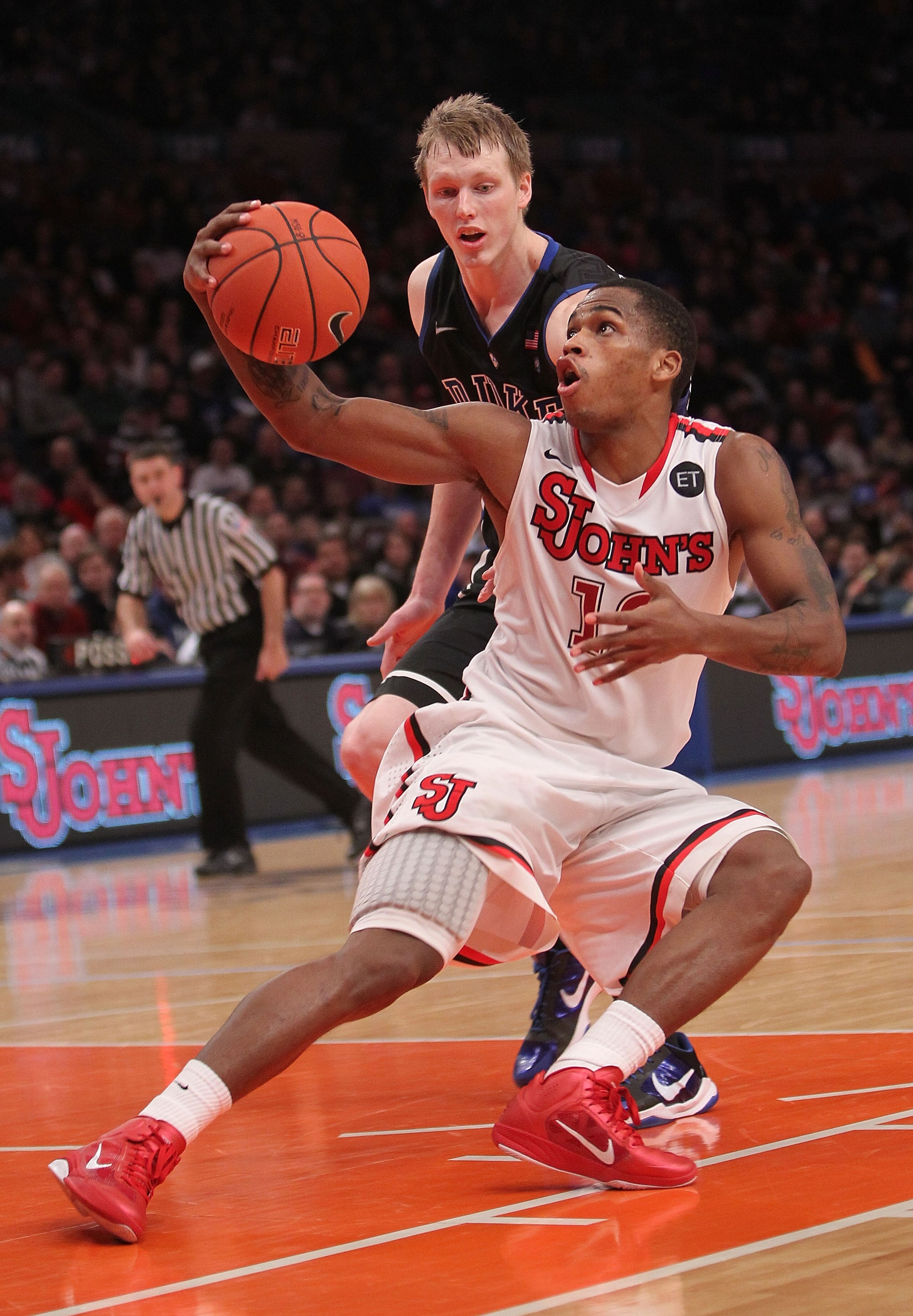 NEW YORK, NY - JANUARY 30: Dwight Hardy #12 of the St. John's Red Storm fakes in front of Kyle Singler #12 of the Duke Blue Devils  at Madison Square Garden on January 30, 2011 in New York City.  (Photo by Nick Laham/Getty Images)