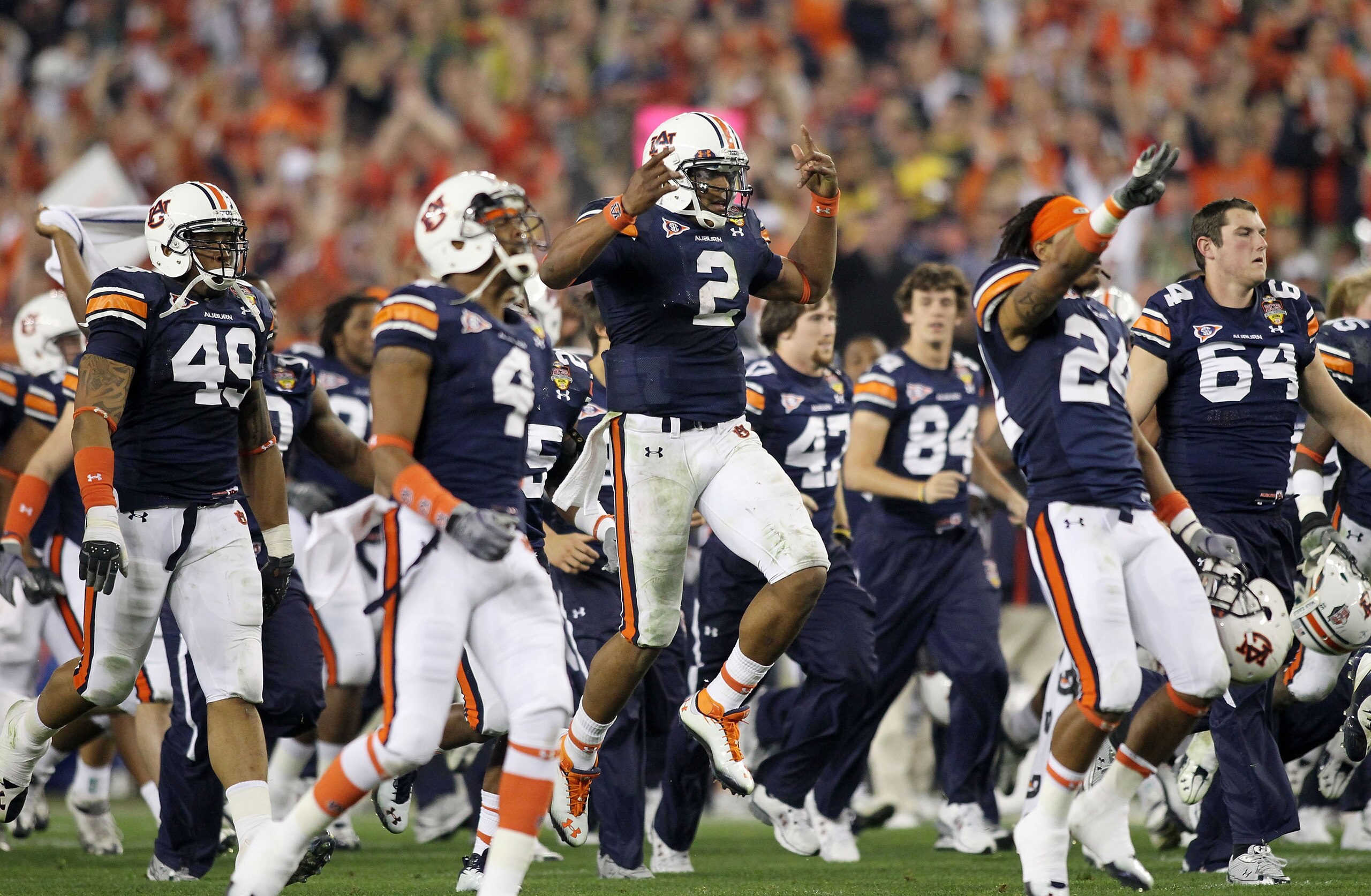 GLENDALE, AZ - JANUARY 10: Quarterback Cameron Newton #2 of the Auburn Tigers celebrates the Tigers 22-19 victory with his team after defeating the Oregon Ducks in the Tostitos BCS National Championship Game at University of Phoenix Stadium on January 10 GLENDALE, AZ - JANUARY 10: Quarterback Cameron Newton #2 of the Auburn Tigers celebrates the Tigers 22-19 victory with his team after defeating the Oregon Ducks in the Tostitos BCS National Championship Game at University of Phoenix Stadium on January 10