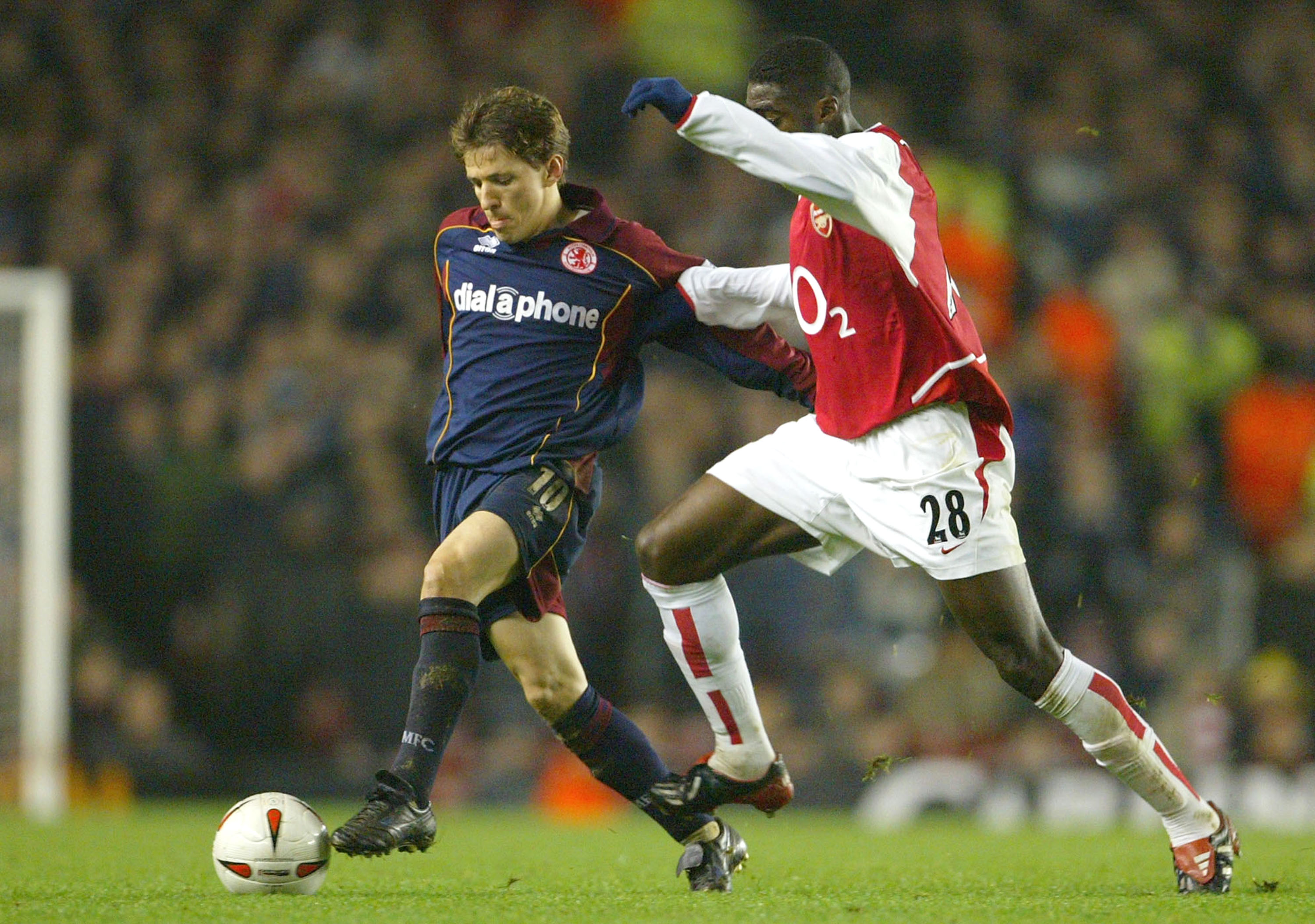 LONDON - JANUARY 20:  Juninho of Middlesbrough is challenged by Kolo Toure of Arsenal during the Carling Cup Semi-Final first leg match between Arsenal and Middlesbrough on January 20, 2004 at Highbury in London, England.  (Photo by Phil Cole/Getty Images