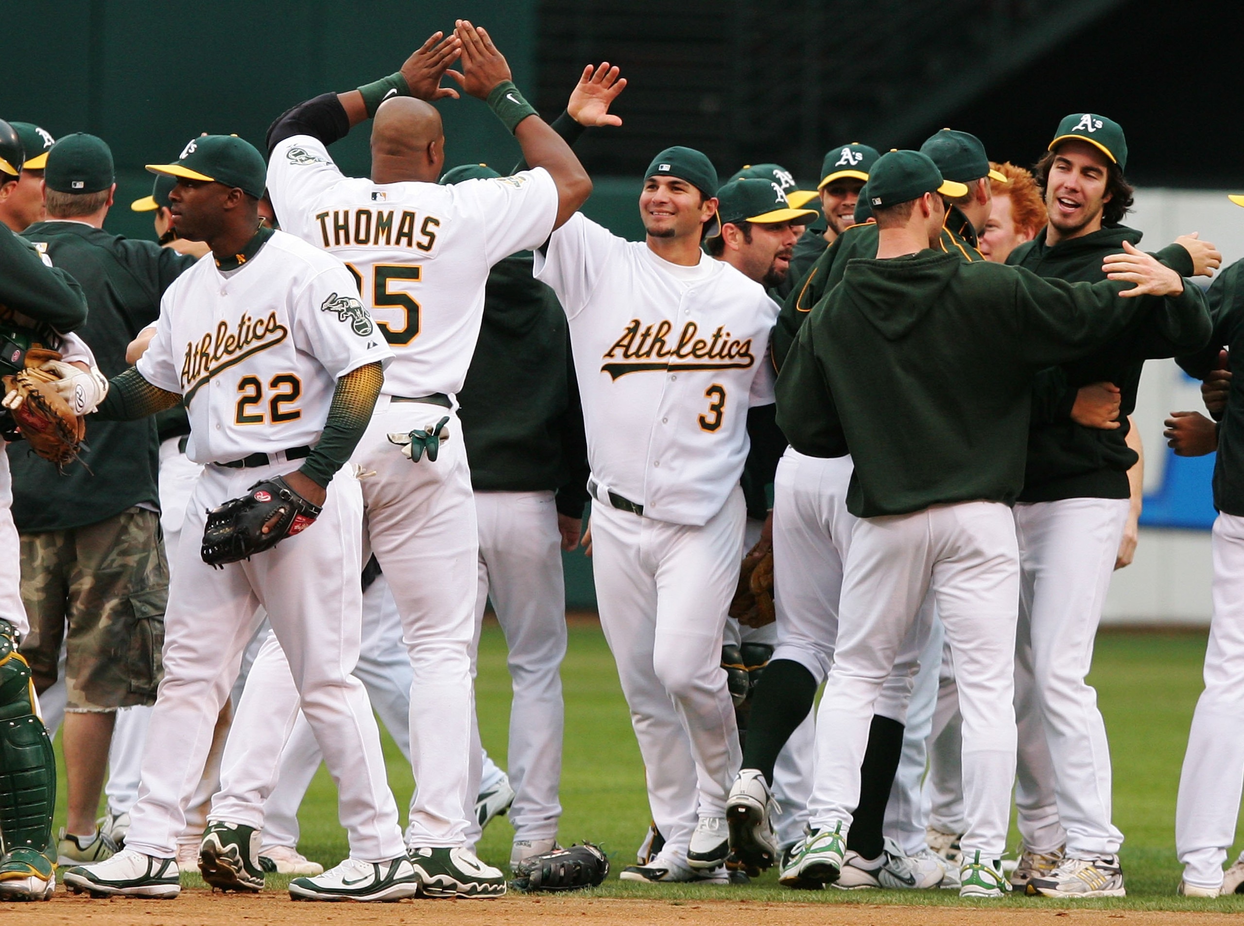OAKLAND, CA - OCTOBER 06:   Eric Chavez #3 of the Oakland Athletics celebrates with teammates after winning game three of the American League Division Series against the Minnesota Twins at McAfee Coliseum on October 6, 2006 in Oakland, California.  (Photo