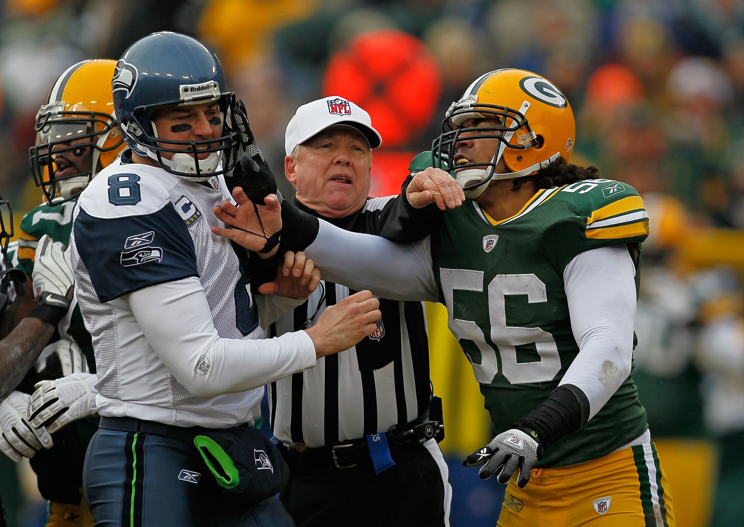GREEN BAY, WI - DECEMBER 27: Referee Walt Coleman #65 breaks up an altercation between Nick Barnett #56 of the Green Bay Packers and Matt Hesselbeck #8 of the Seattle Seahawks at Lambeau Field on December 27, 2009 in Green Bay, Wisconsin. (Photo by Jonath GREEN BAY, WI - DECEMBER 27: Referee Walt Coleman #65 breaks up an altercation between Nick Barnett #56 of the Green Bay Packers and Matt Hesselbeck #8 of the Seattle Seahawks at Lambeau Field on December 27, 2009 in Green Bay, Wisconsin. (Photo by Jonath