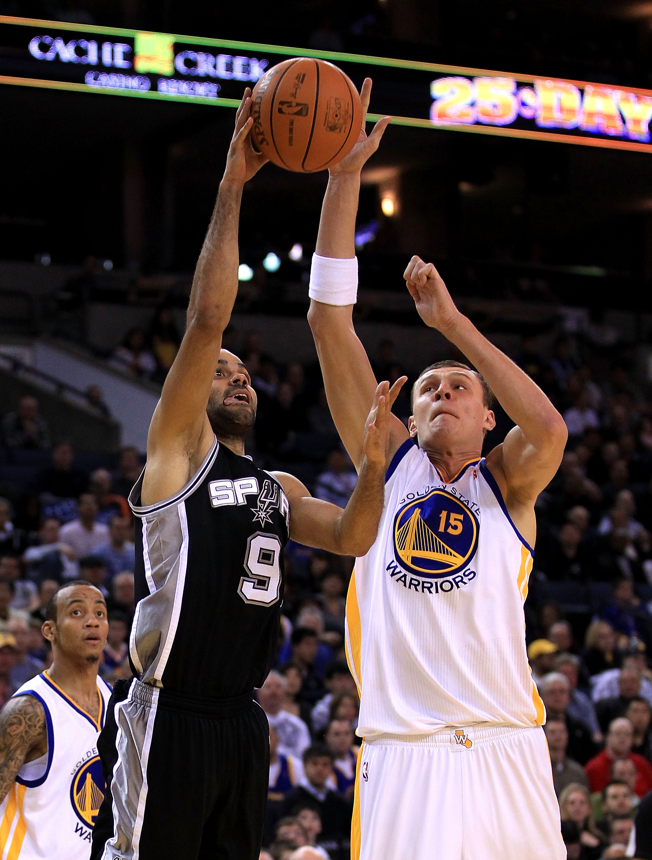 OAKLAND, CA - JANUARY 24:  Tony Parker #9 of the San Antonio Spurs goes up for a shot against Andris Biedrins #15 of the Golden State Warriors at Oracle Arena on January 24, 2011 in Oakland, California.  NOTE TO USER: User expressly acknowledges and agree