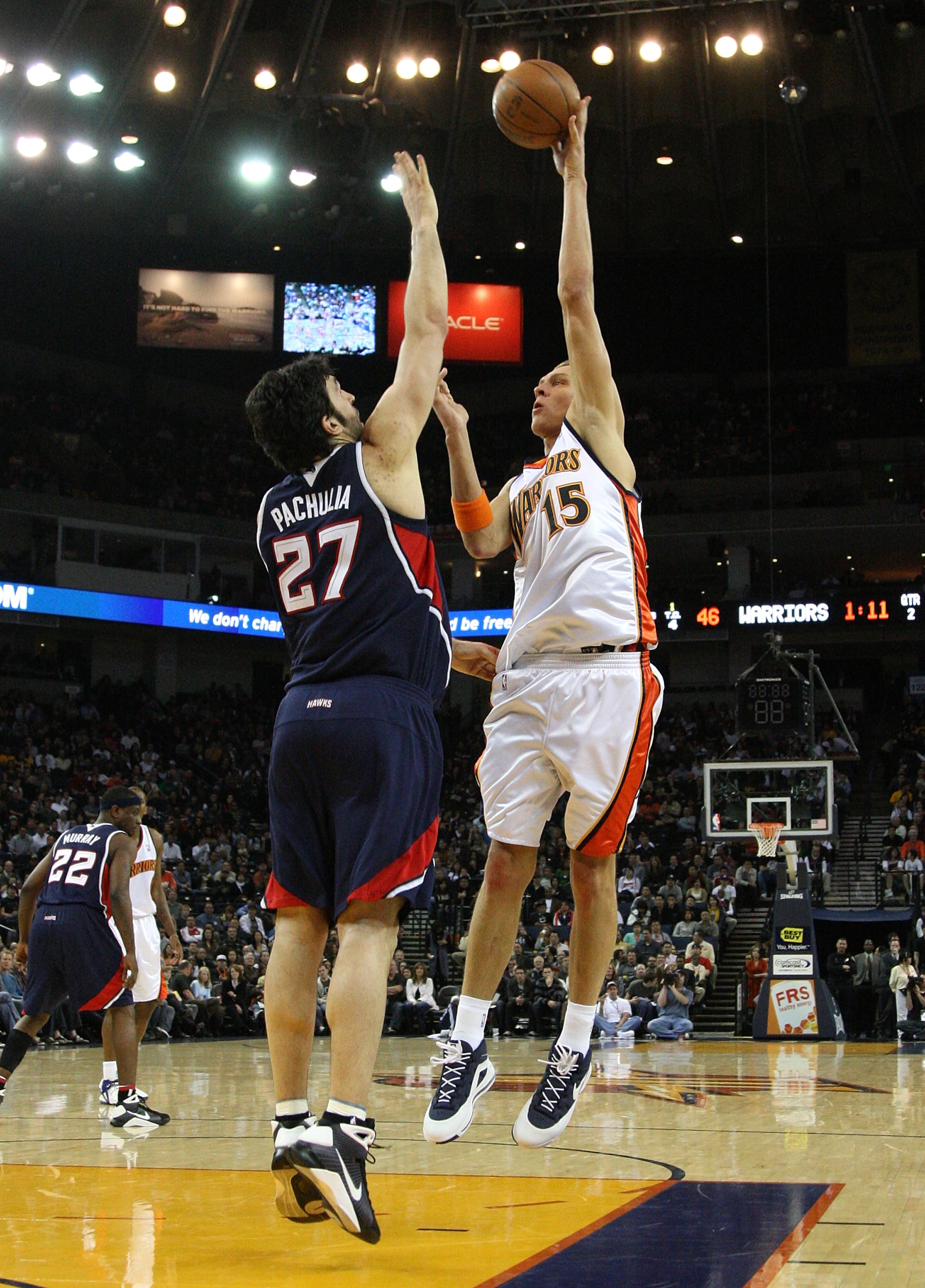 OAKLAND, CA - JANUARY 16:  Andris Biedrins #15 of the Golden State Warriors shoots over Zaza Pachulia #27 of the Atlanta Hawks during an NBA game on January 16, 2009 at Oracle Arena in Oakland, California. NOTE TO USER: User expressly acknowledges and agr