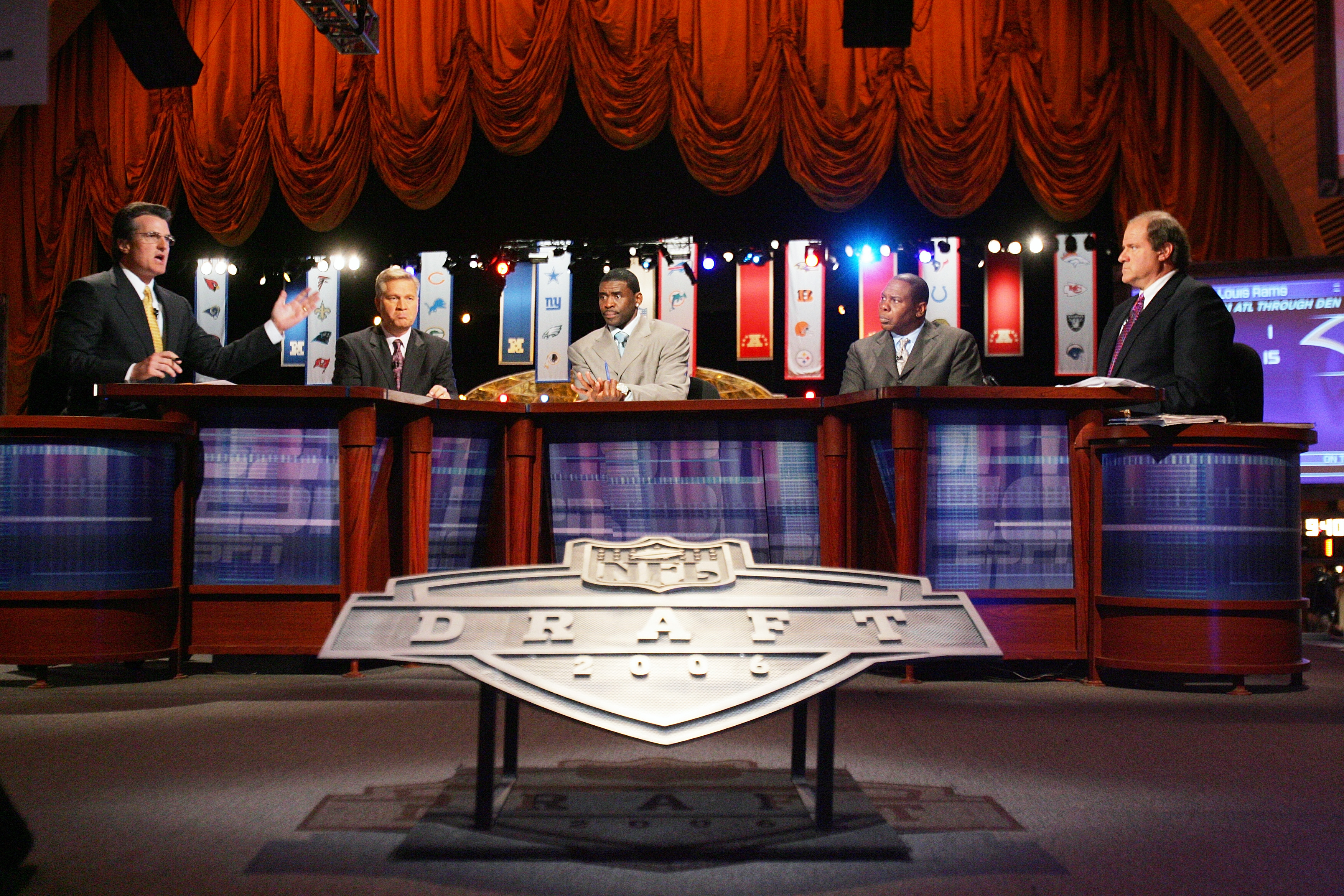NEW YORK - APRIL 29:  (L-R) Mel Kiper, Chris Mortensen, Michael Irvin, Tom Jackson and Chris Berman of ESPN broadcast their coverage during the 2006 NFL Draft on April 29, 2006 at Radio City Music Hall in New York, New York. (Photo by Chris Trotman/Getty