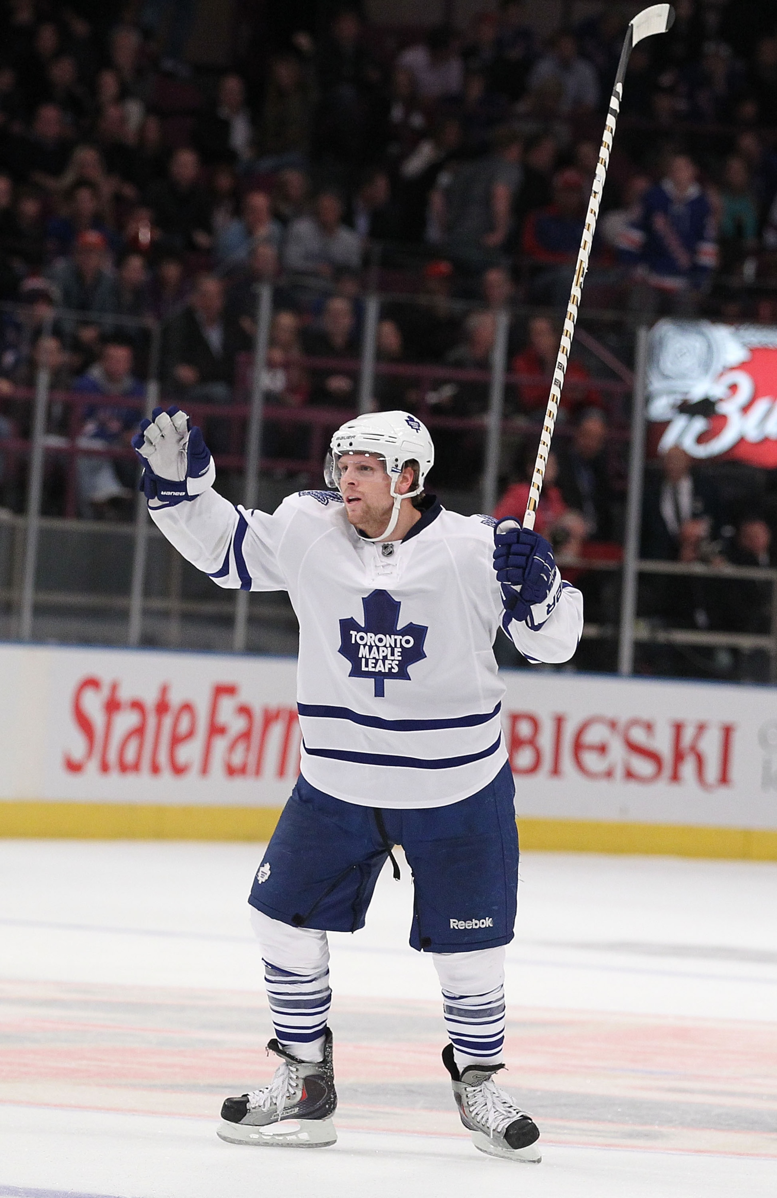 NEW YORK - OCTOBER 15:  Phil Kessel #81 of the Toronto Maple Leafs celebrates his overtime winning goal with teamates against Henrik Lundqvist  of the New York Rangers during their game on October 15, 2010 at Madison Square Garden in New York City.  (Phot