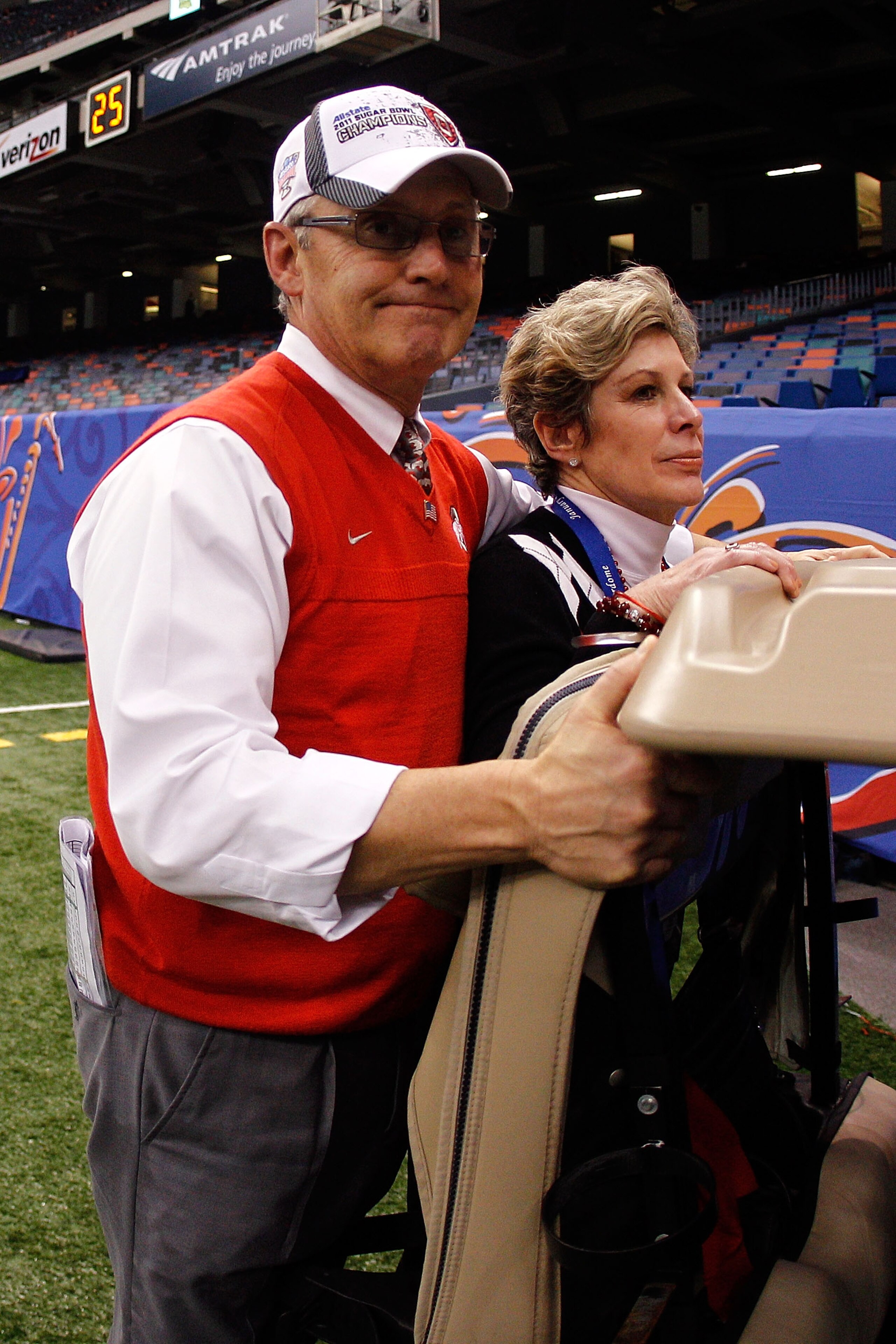 NEW ORLEANS, LA - JANUARY 04:  Head coach Jim Tressel of the Ohio State Buckeyes and wife Ellen Tressel are carted off the field after the Buckeyes 31-26 victory against the Arkansas Razorbacks during the Allstate Sugar Bowl at the Louisiana Superdome on