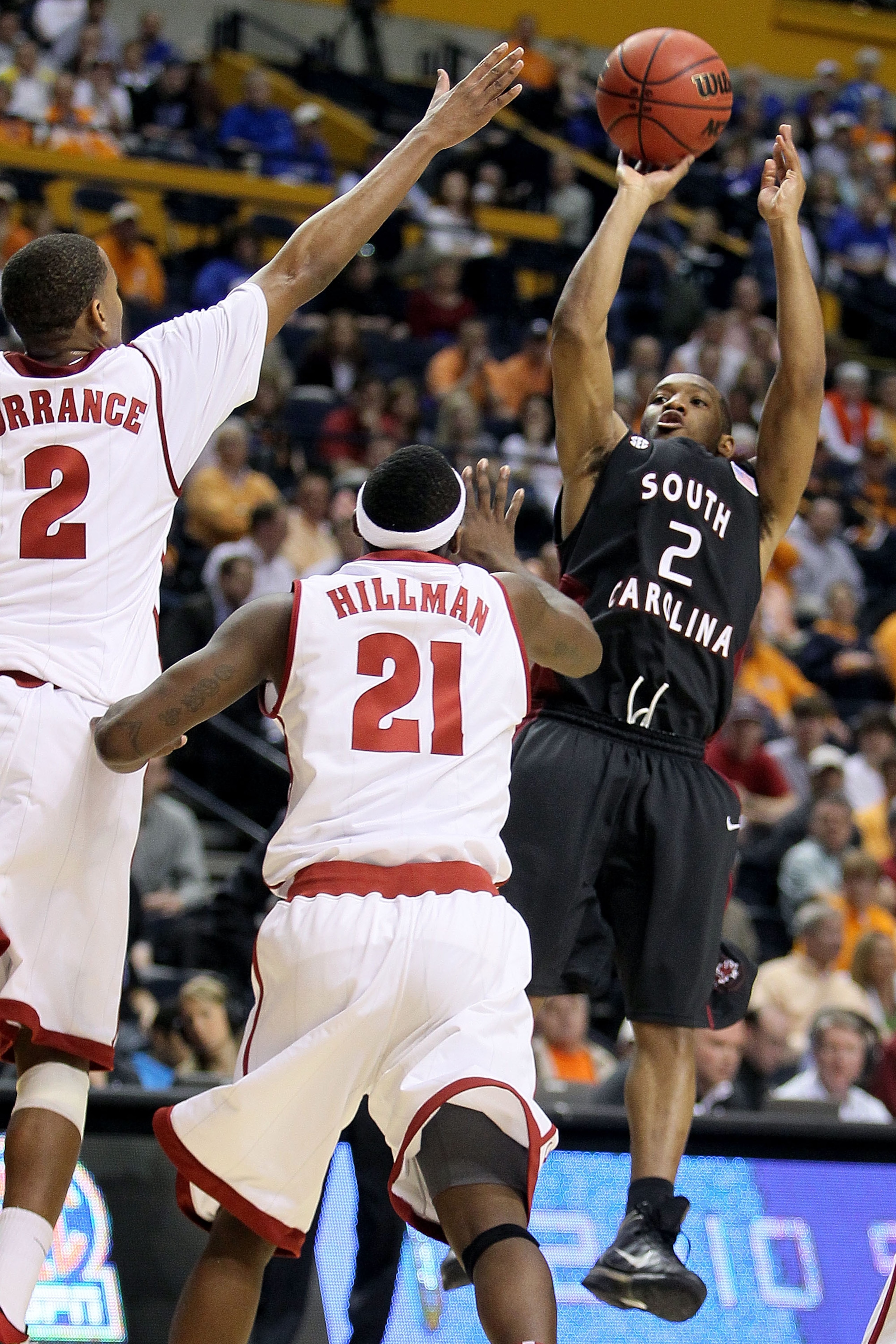 NASHVILLE, TN - MARCH 11:  Devan Downey #2 of the South Carolina attempts a shot in the second half against Mikhail Torrance #2 and Senario Hillman #21 of the Alabama Crimson Tide Gamecocks during the first round of the SEC Men's Basketball Tournament at