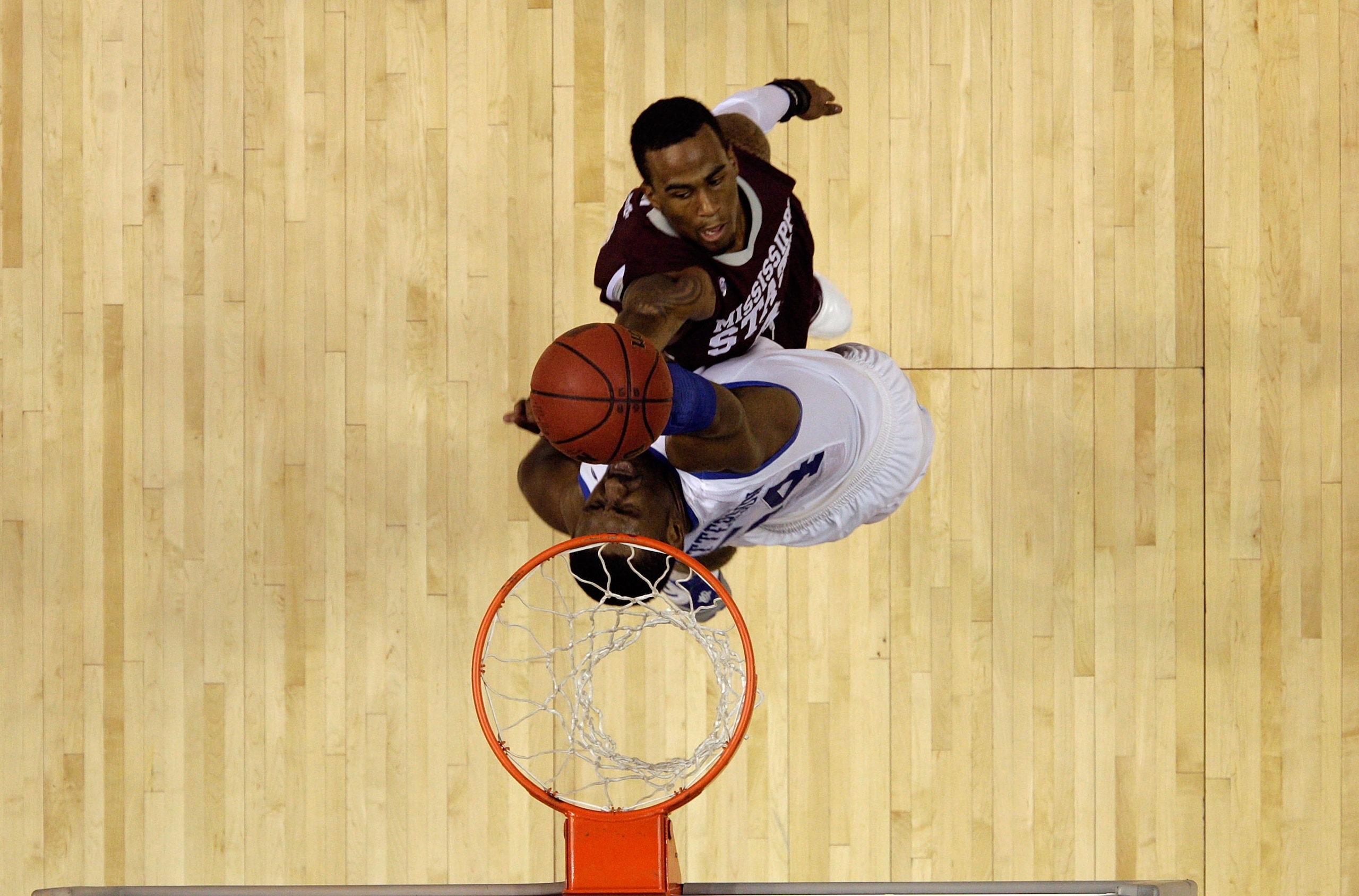 NASHVILLE, TN - MARCH 14:  Dee Bost #3 of the Mississippi State Bulldogs drives for a shot attempt against Patrick Patterson #54 of the Kentucky Wildcats during the final of the SEC Men's Basketball Tournament at the Bridgestone Arena on March 14, 2010 in