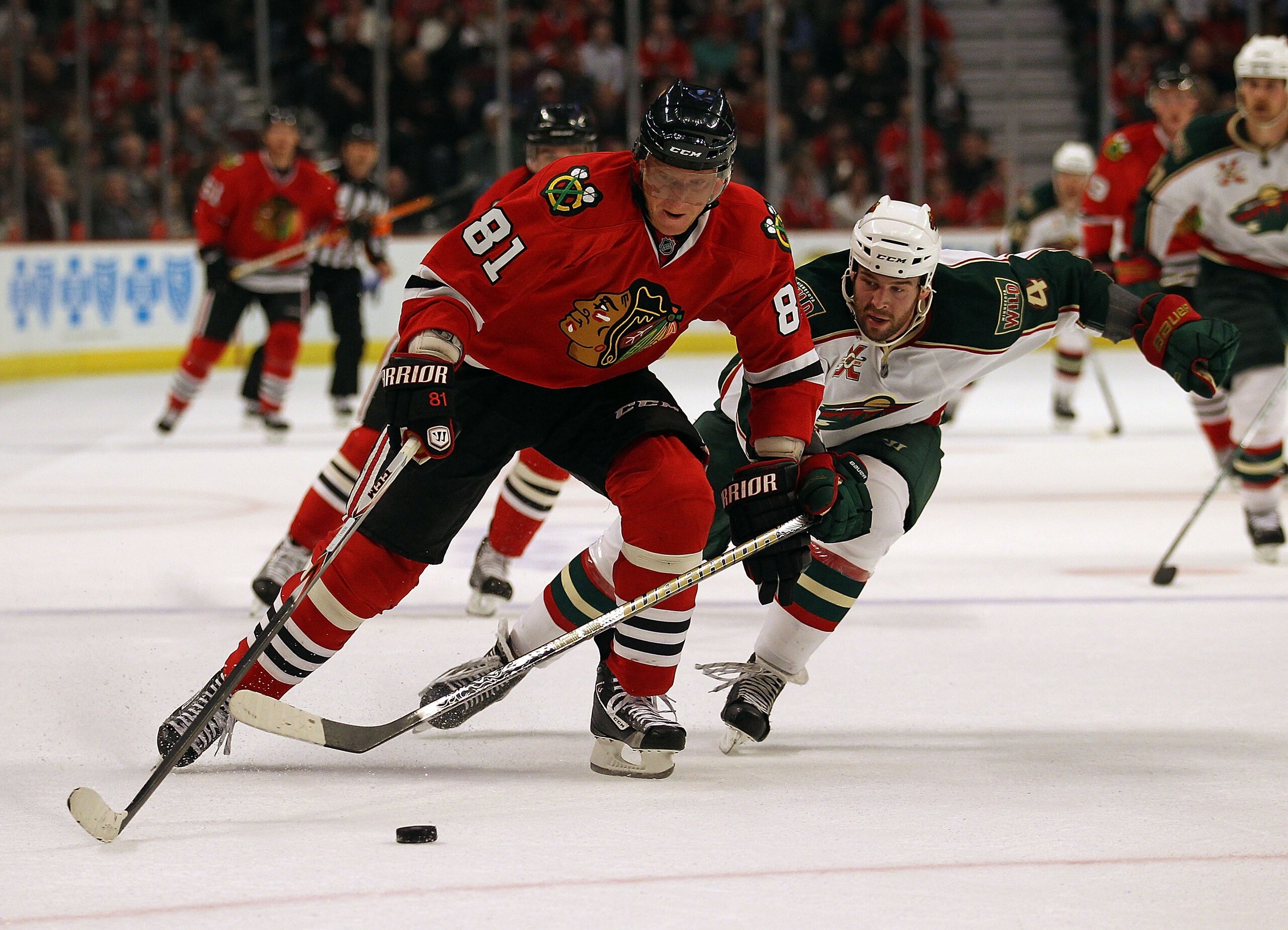 CHICAGO, IL - FEBRUARY 16: Marian Hossa #81 of the Chicago Blackhawks skates up the ice under pressure from Clayton Stoner #4 of the Minnesota Wild at the United Center on February 16, 2011 in Chicago, Illinois. (Photo by Jonathan Daniel/Getty Images)