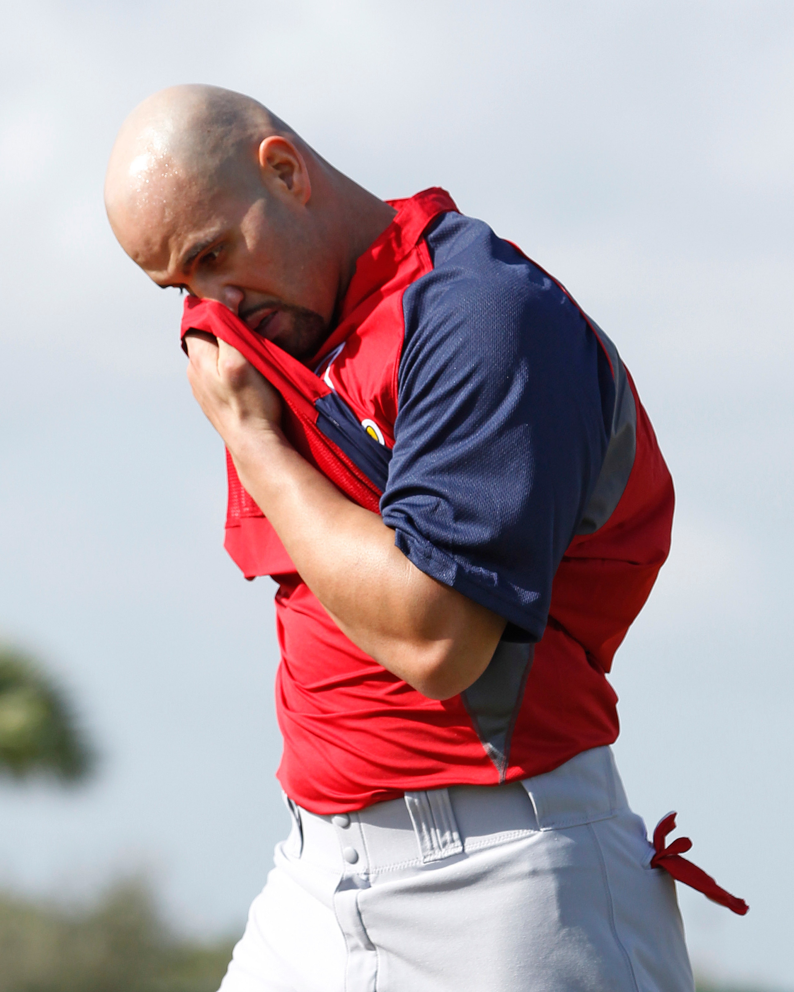 JUPITER, FL - FEBRUARY 17: Albert Pujols #5 of the St. Louis Cardinals wipes his face off during fielding practice at Roger Dean Stadium on February 17, 2011 in Jupiter, Florida. (Photo by Joel Auerbach/Getty Images)