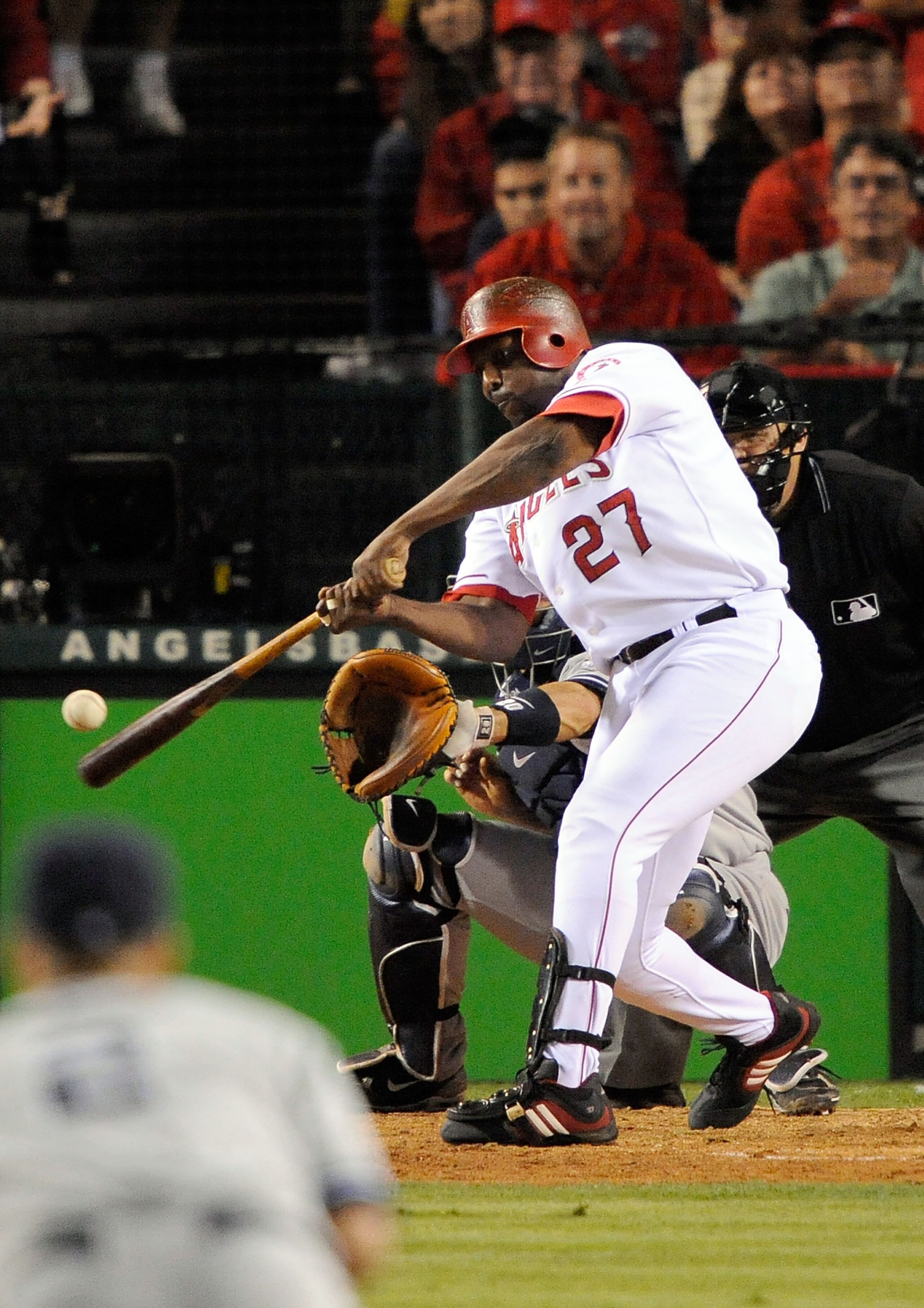 ANAHEIM, CA - OCTOBER 22: Vladimir Guerrero #27 of the Los Angeles Angels of Anaheim singles to center field scoring teammate Erick Aybar #2 (Not Shown) during the seventh inning in Game Five of the ALCS against the New York Yankees during the 2009 MLB Pl